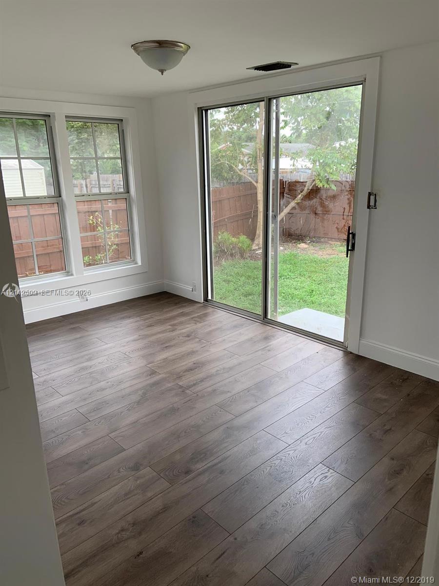 Wood-finish flooring, multi-pane windows, and sliding glass door