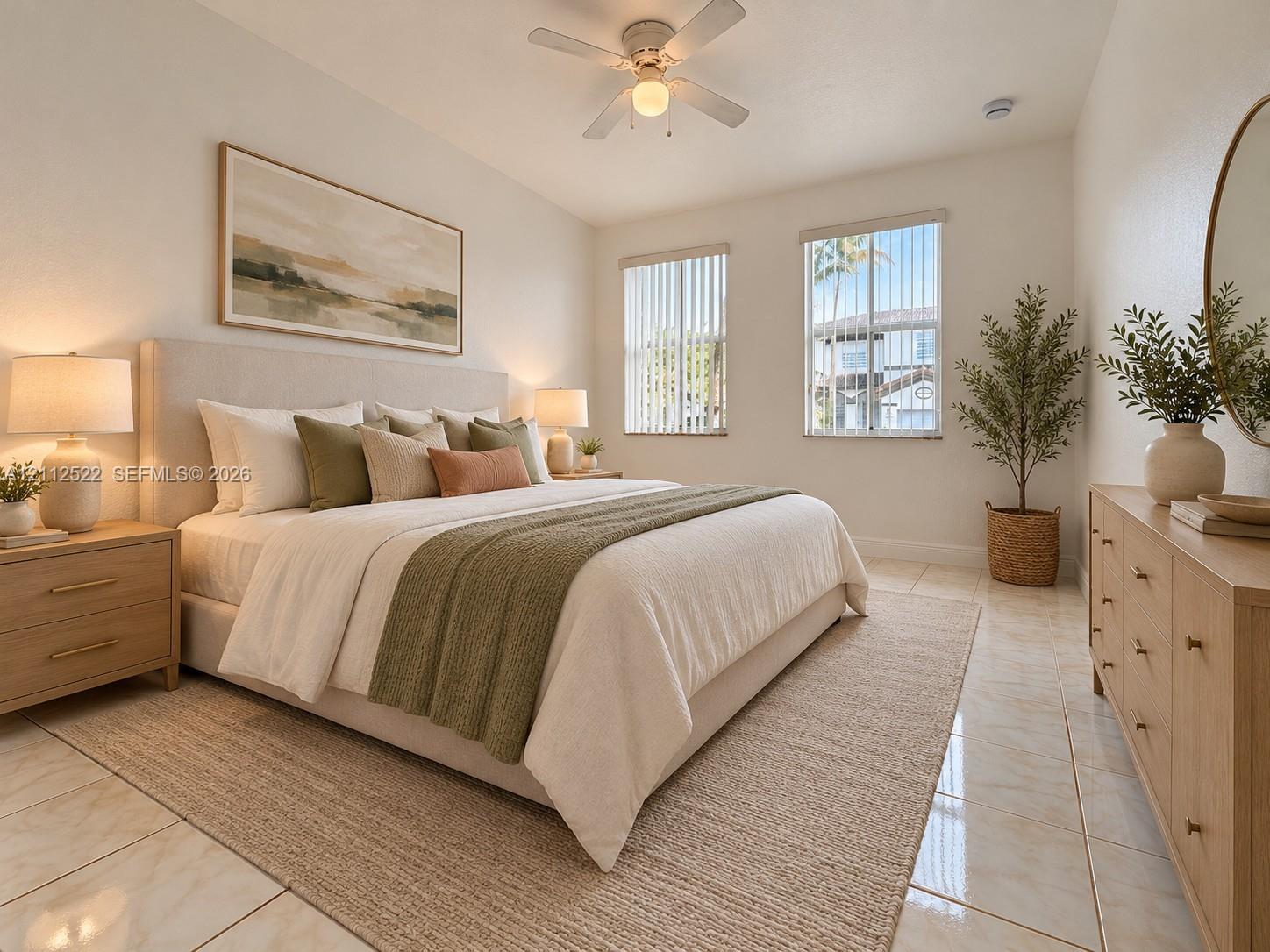 Neutral-toned tile flooring, light-toned wall finishes, ceiling fan with integrated lighting, and dual windows with vertical blinds
