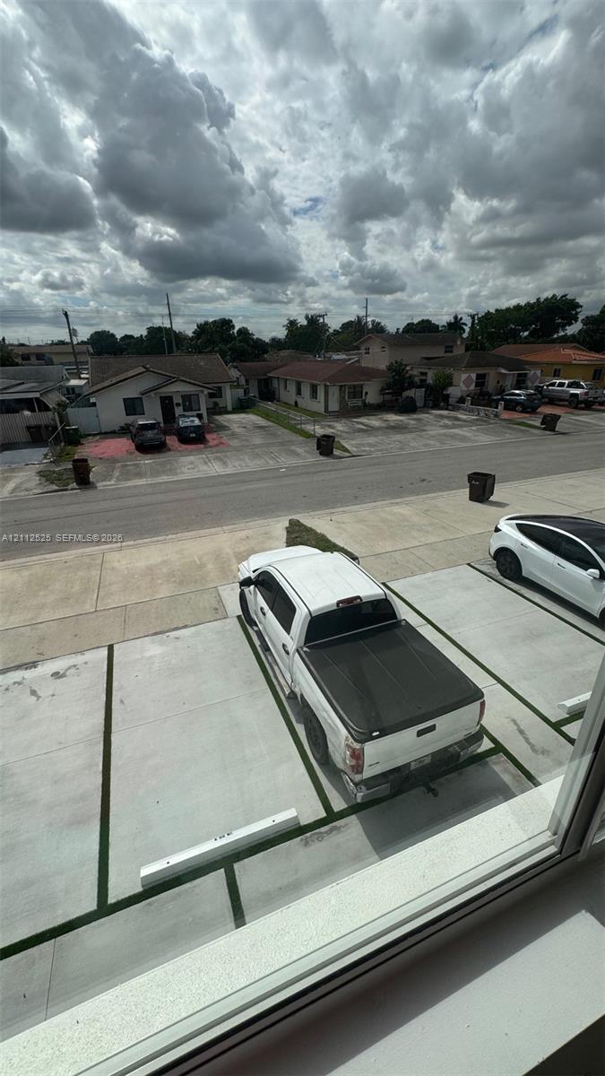 Designated surface parking area featuring concrete paving and individual stall dividers