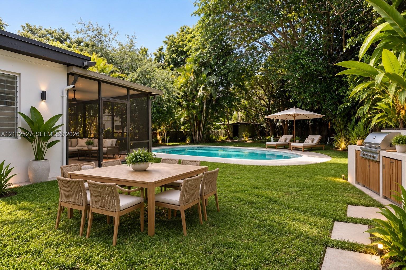 Screened patio, swimming pool with concrete surround, built-in outdoor kitchen with stainless steel grill, and manicured lawn