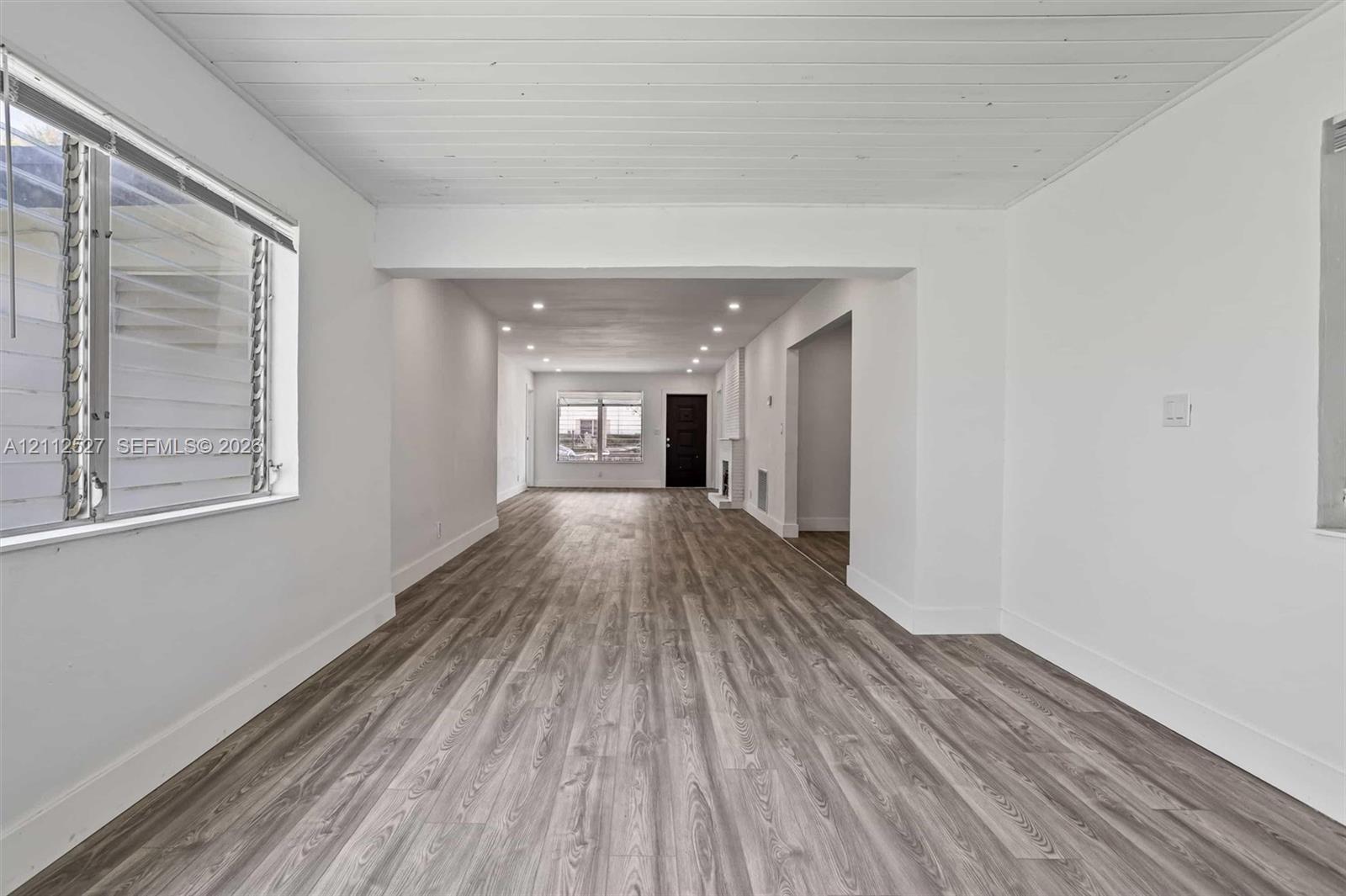 Interior featuring wood-finish flooring, recessed lighting, and a plank-style ceiling
