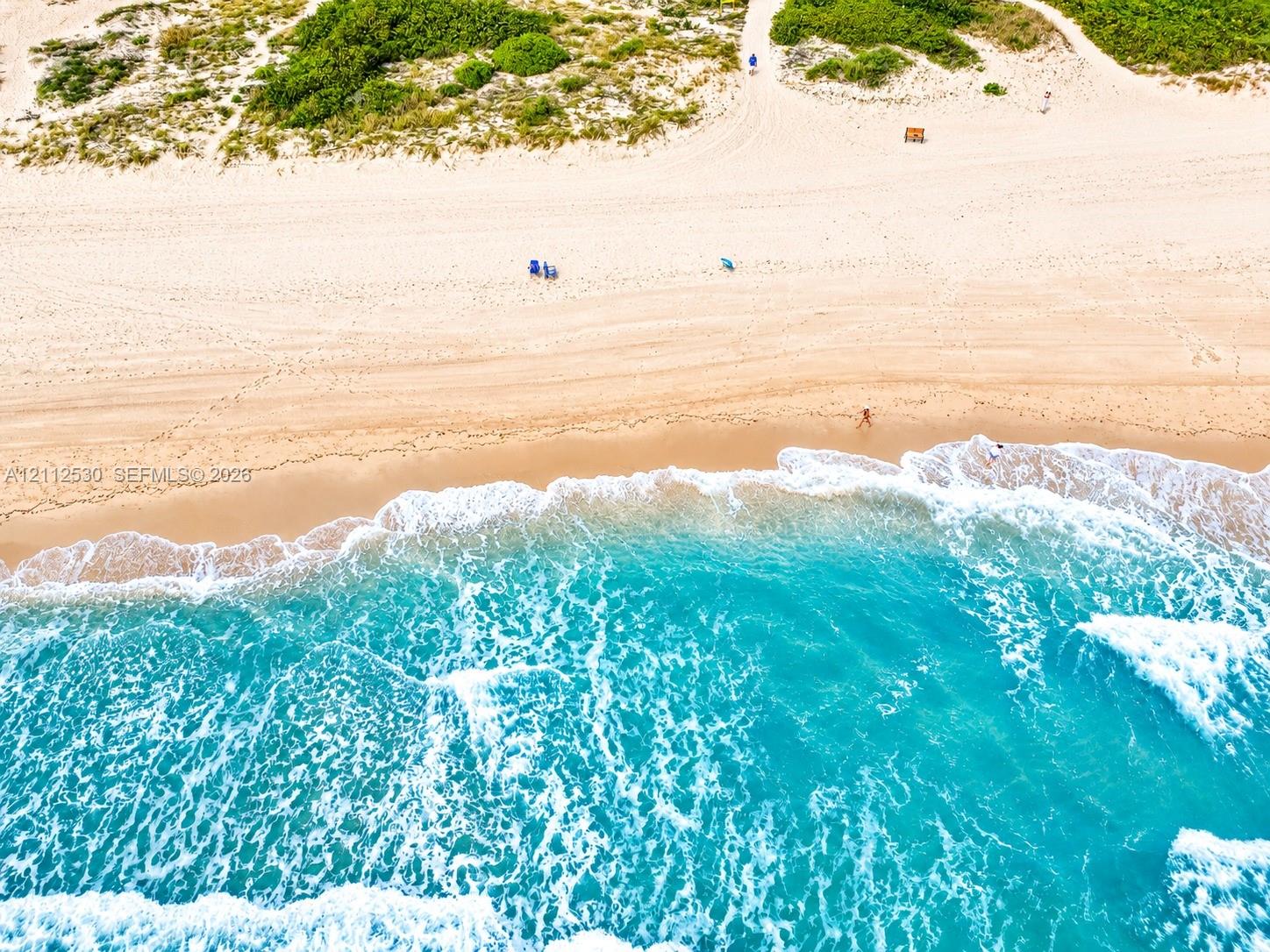 Coastal property with direct sand beach access, natural dune vegetation, and shoreline frontage