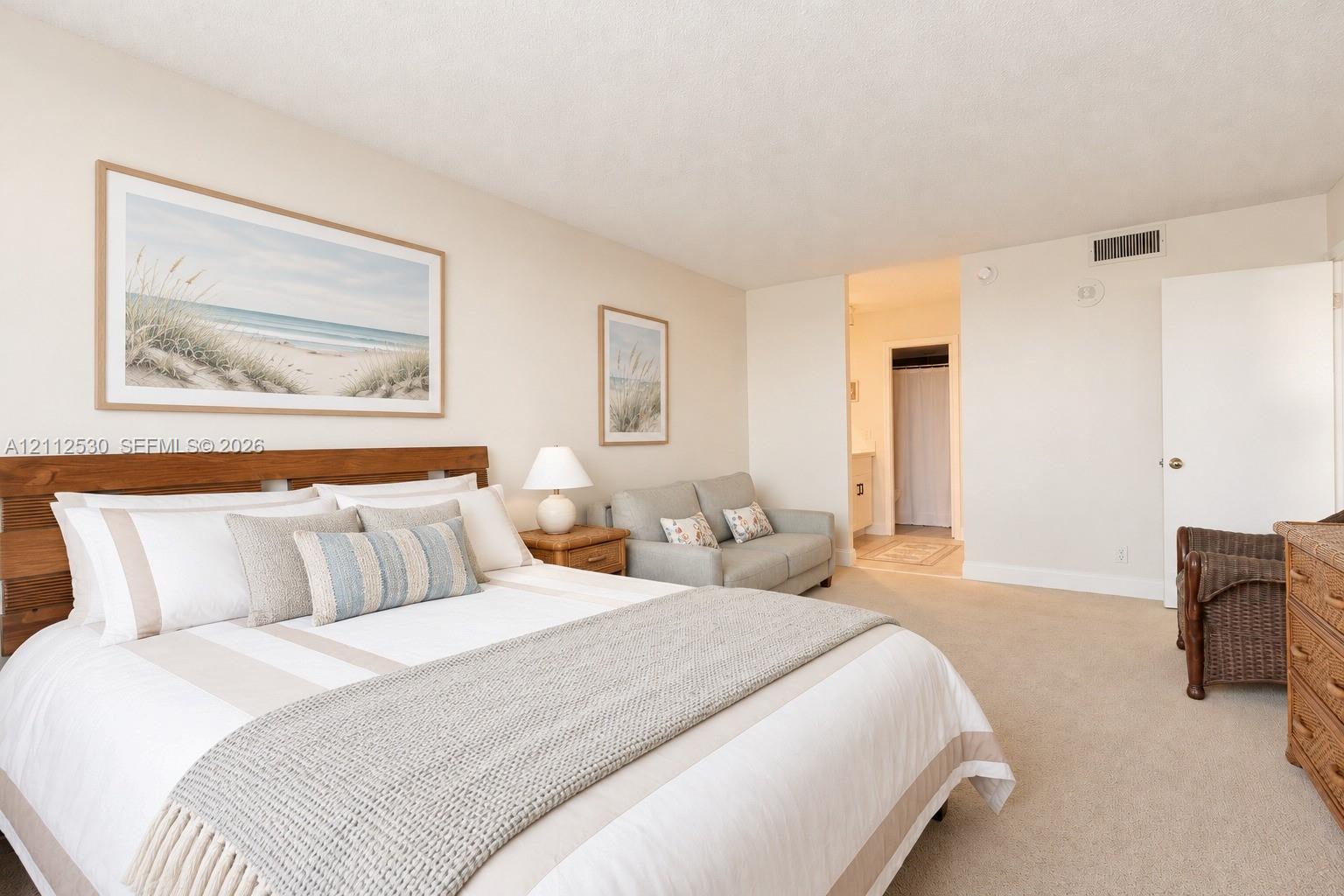 Neutral-toned carpeting, smooth-finish ceiling, and interior flush doors