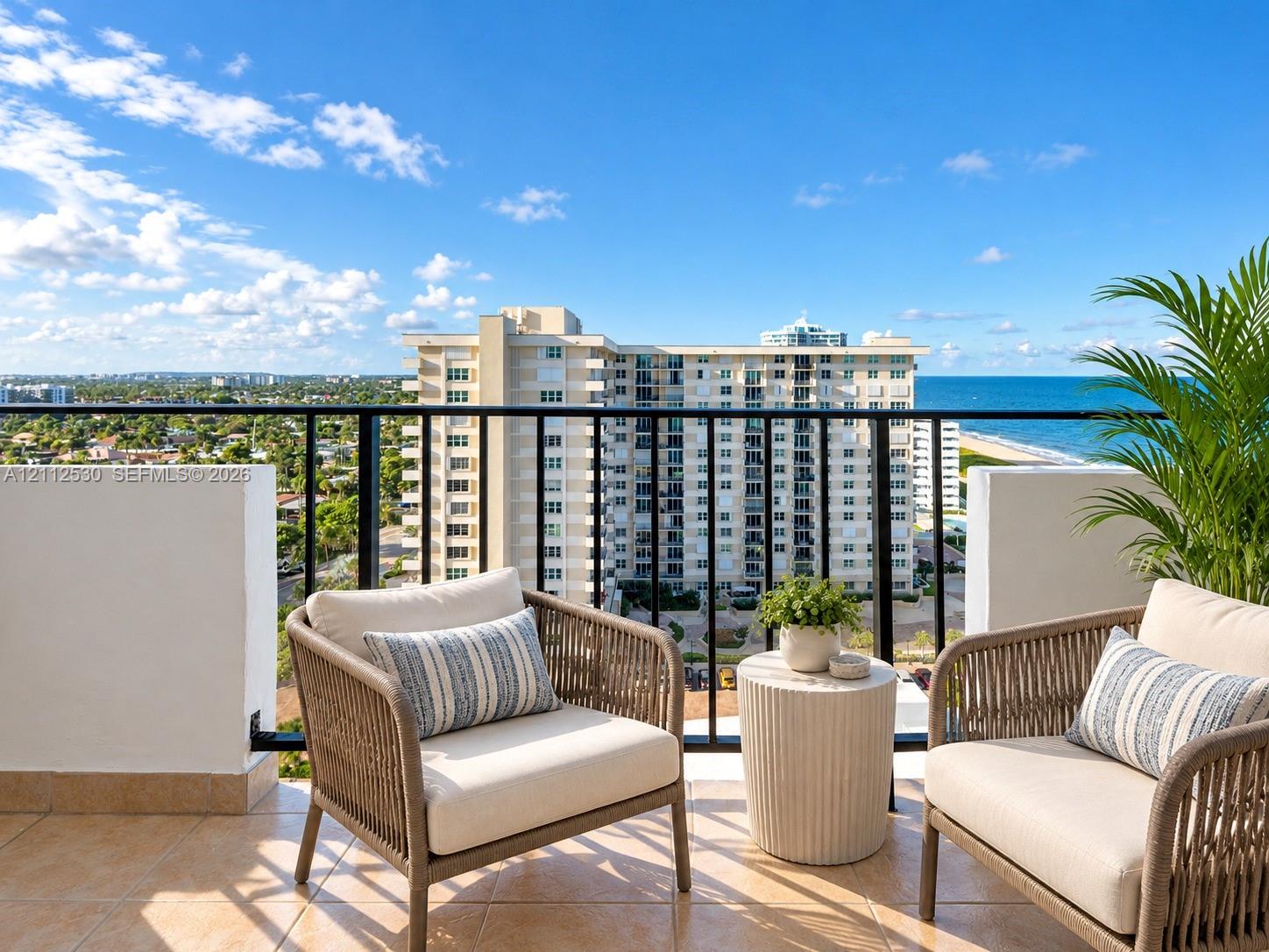 Private balcony featuring tile flooring and black metal railings with an unobstructed ocean and coastal horizon