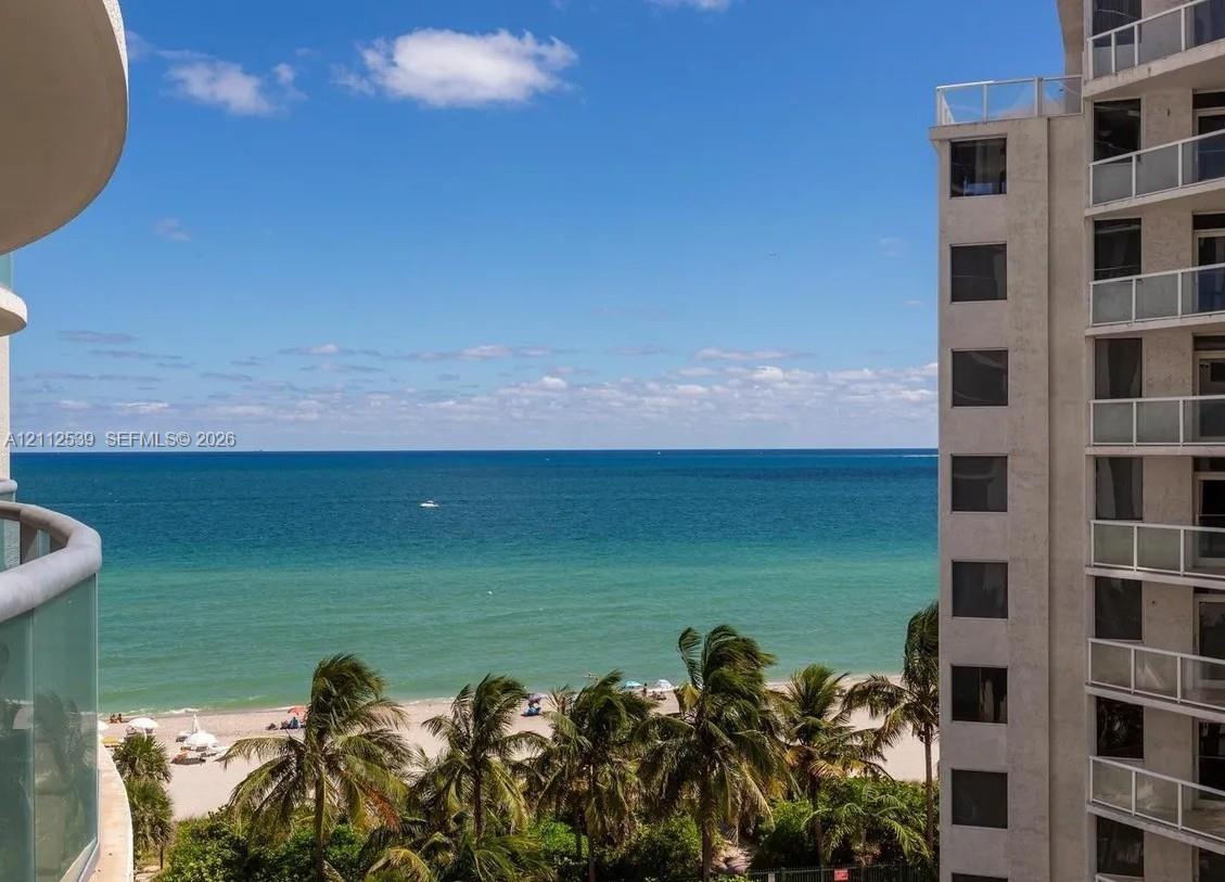 Private balcony featuring glass railings and direct oceanfront exposure