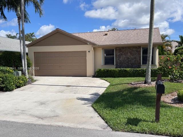 Single-story exterior featuring a stone facade, beige stucco siding, an attached garage, and a concrete driveway Single-story exterior featuring a stone facade, beige stucco siding, an attached garage, and a concrete driveway