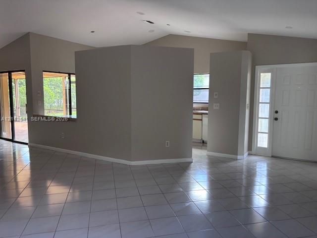 Vaulted ceilings with recessed lighting, large ceramic tile flooring, solid core entry door with sidelight, and sliding glass patio doors Vaulted ceilings with recessed lighting, large ceramic tile flooring, solid core entry door with sidelight, and sliding glass patio doors
