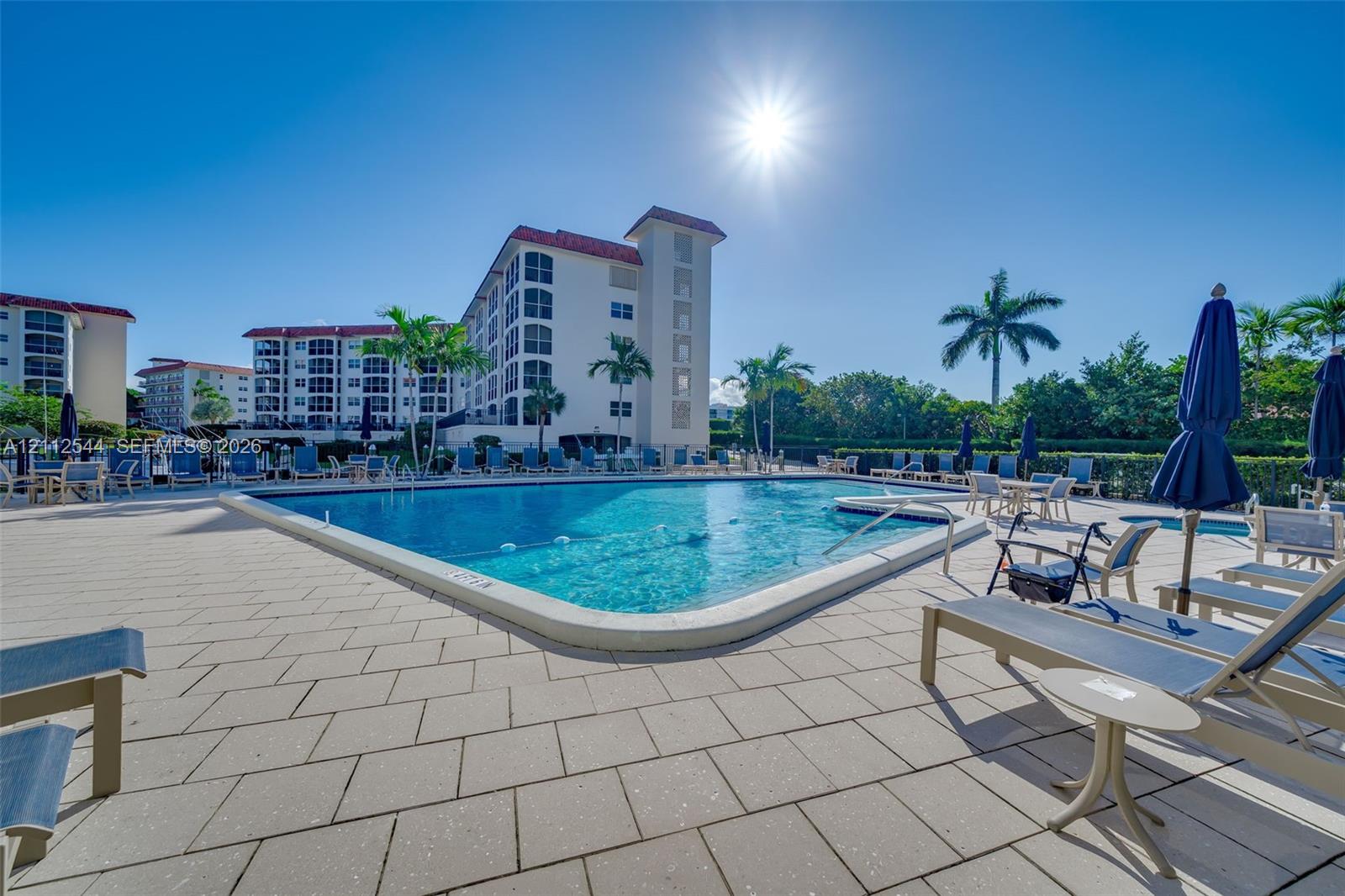 Swimming pool with paved surround and integrated hot tub