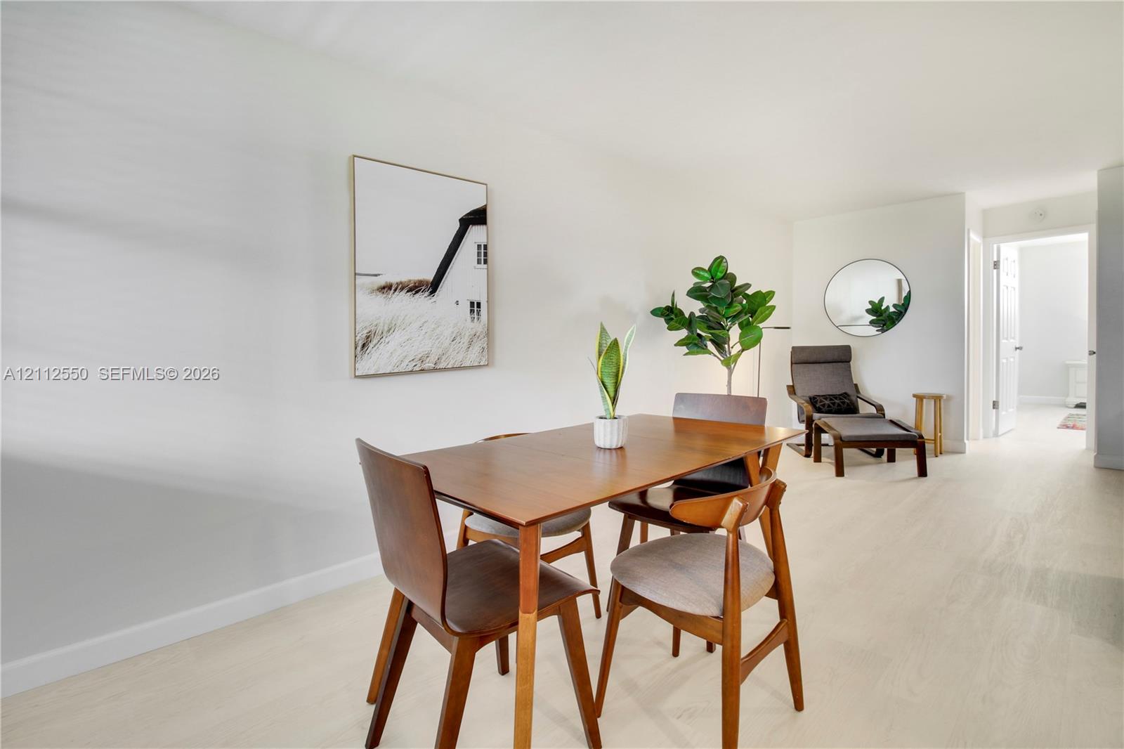 Bright interior space featuring neutral wall paint and light-toned wood-finish flooring