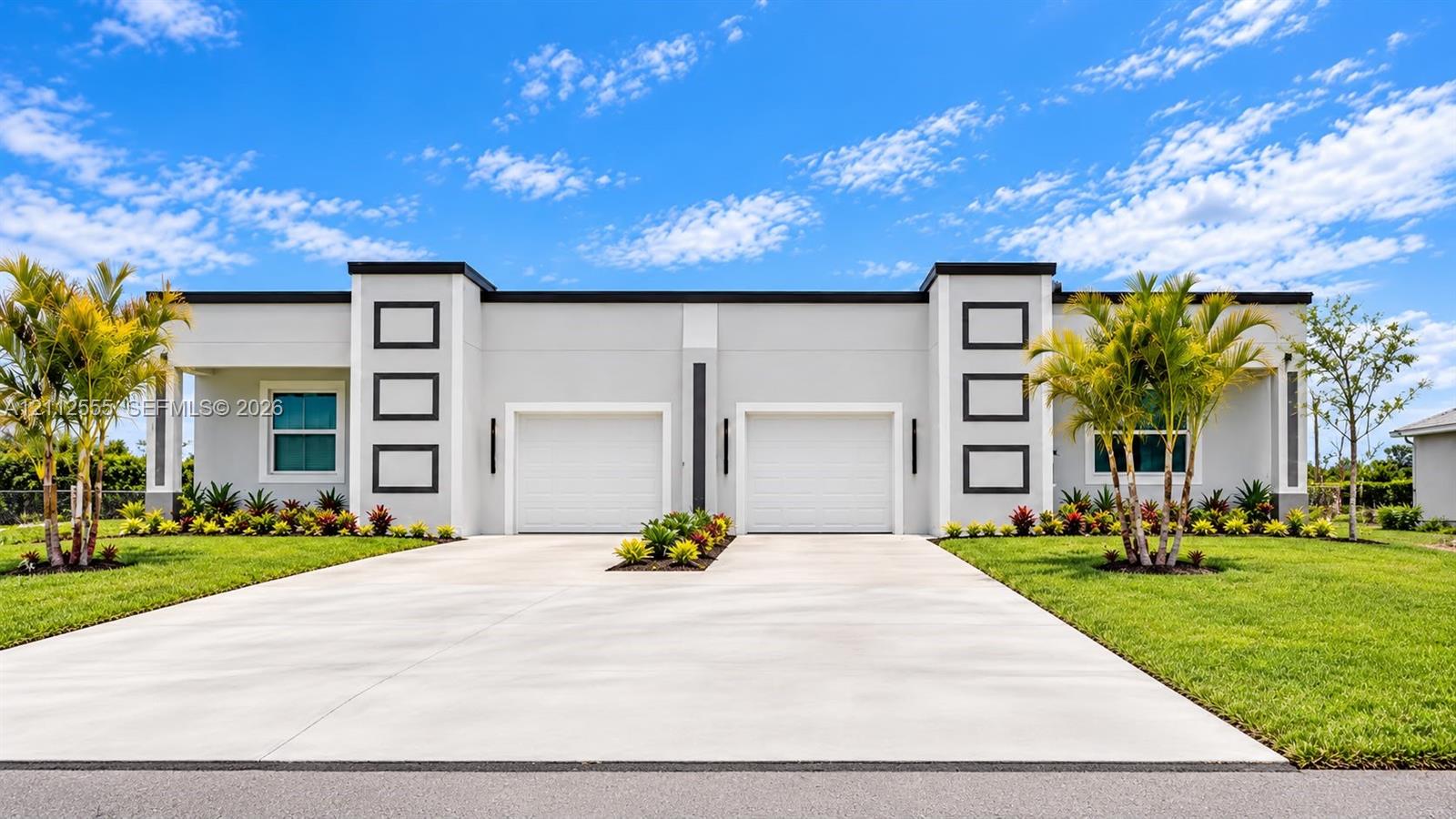 Contemporary exterior featuring a flat roofline, dual-garage configuration, concrete driveway, and minimalist architectural trim Contemporary exterior featuring a flat roofline, dual-garage configuration, concrete driveway, and minimalist architectural trim