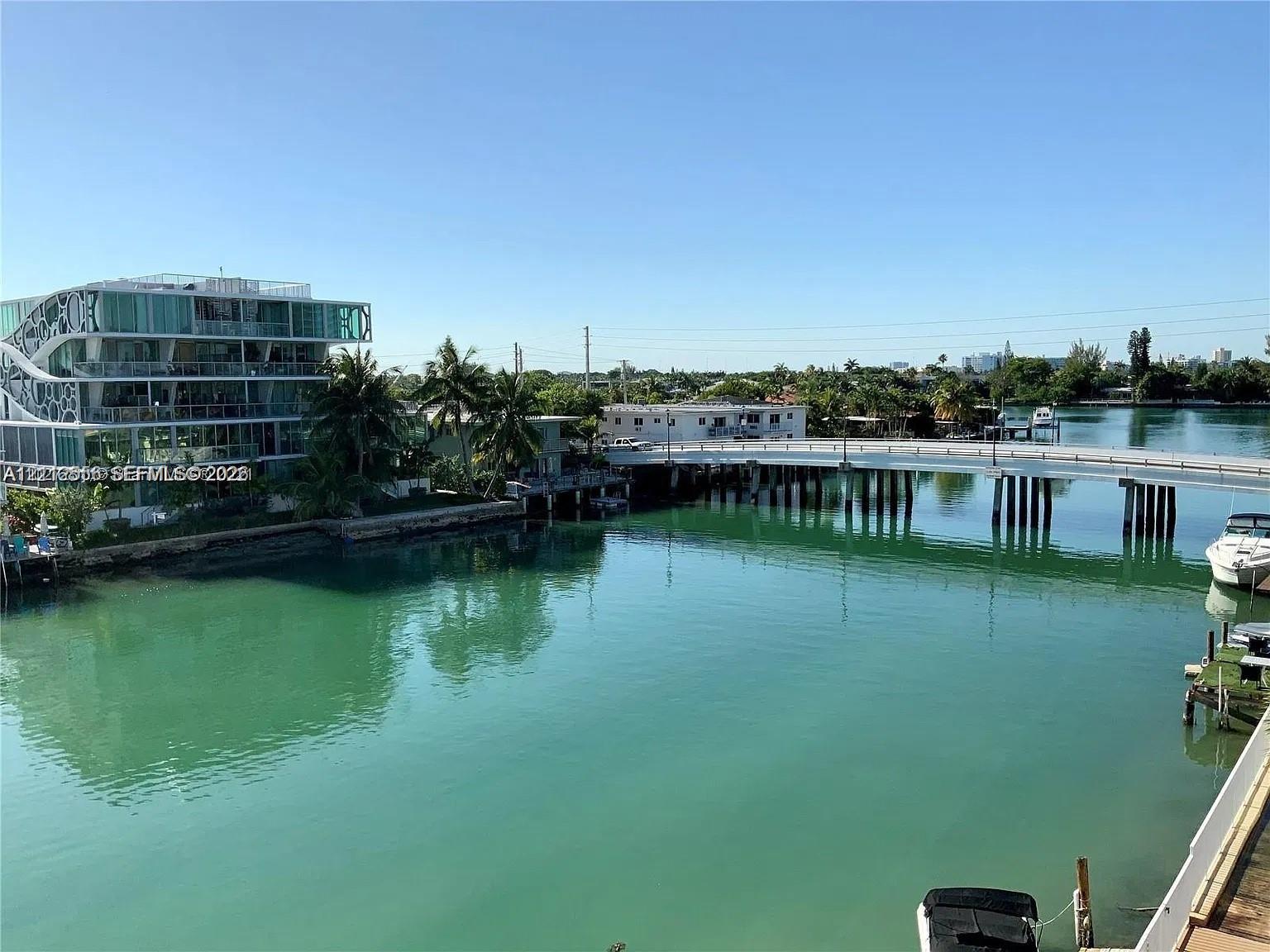 Waterfront setting with direct canal access, concrete seawall, and mature palm trees Waterfront setting with direct canal access, concrete seawall, and mature palm trees