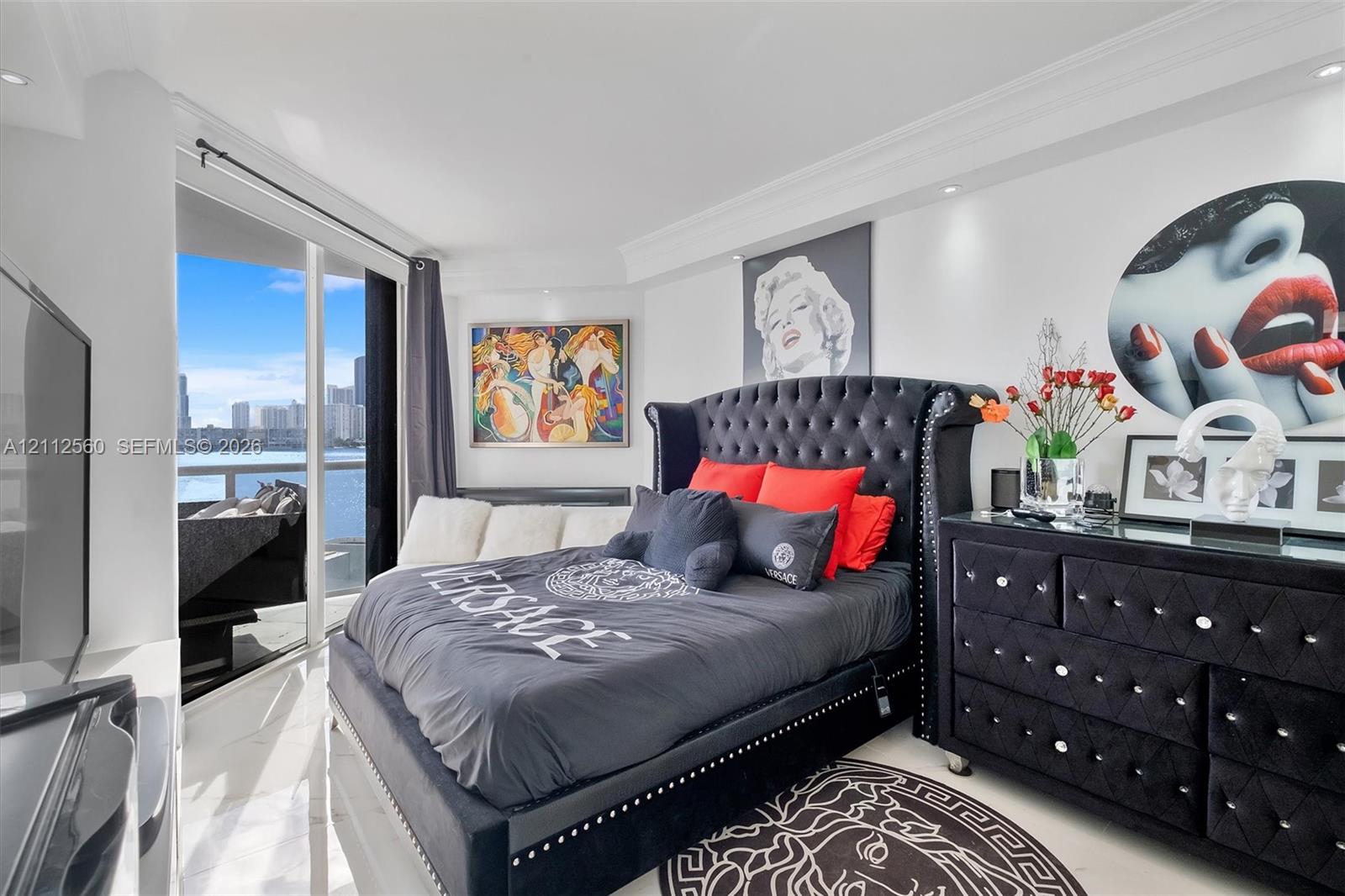 Floor-to-ceiling glass paneling, polished stone flooring, crown molding, and recessed lighting throughout