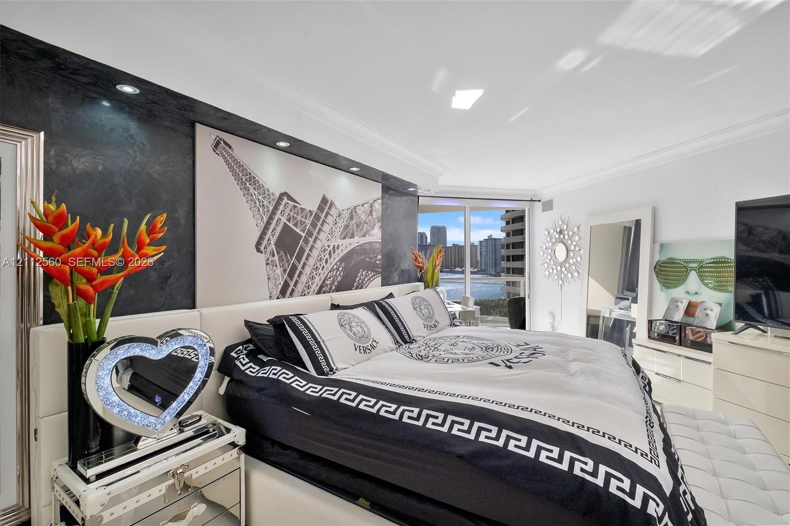 Textured charcoal feature wall with integrated recessed lighting, floor-to-ceiling glass sliding doors, and crown molding