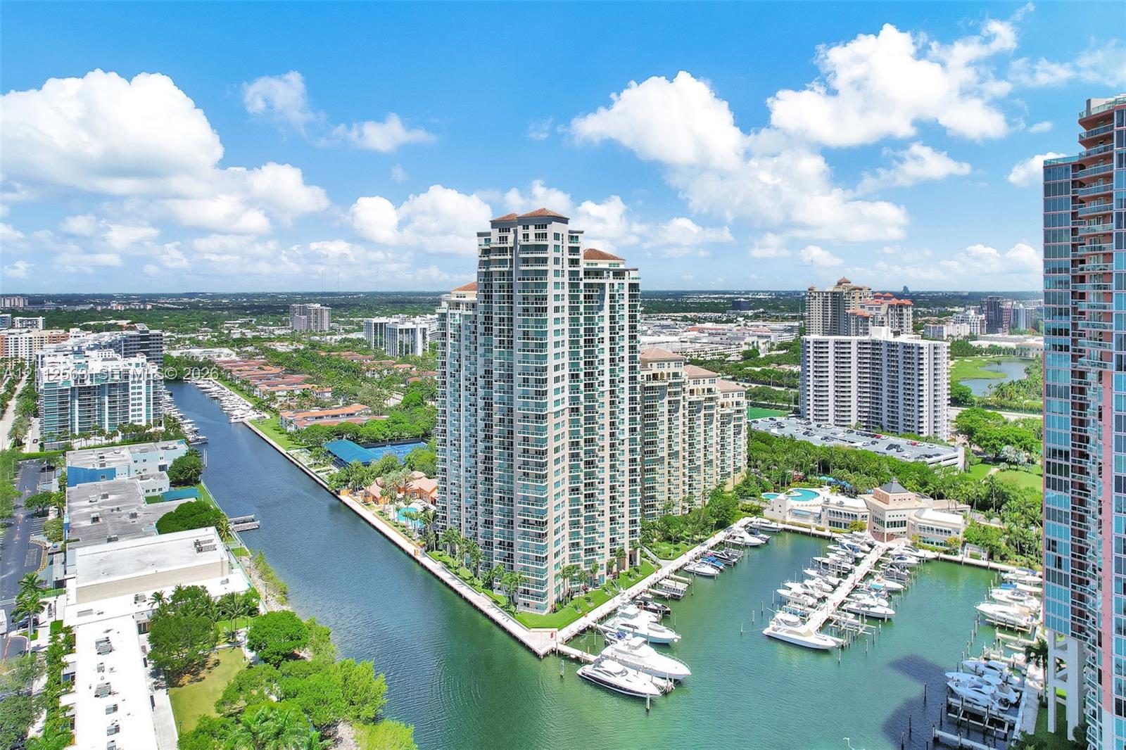 High-rise residential tower featuring private balconies, integrated deep-water marina, concrete dockage, and extensive waterfront footage