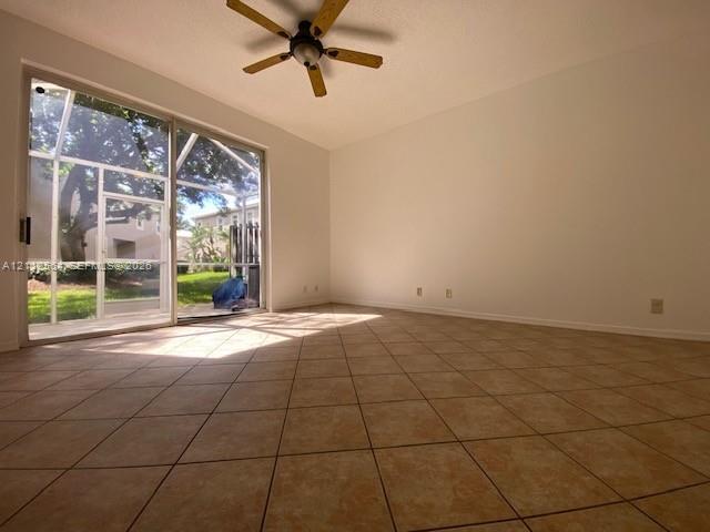 Living room with tile flooring, sliding glass door opening to a screened-in patio