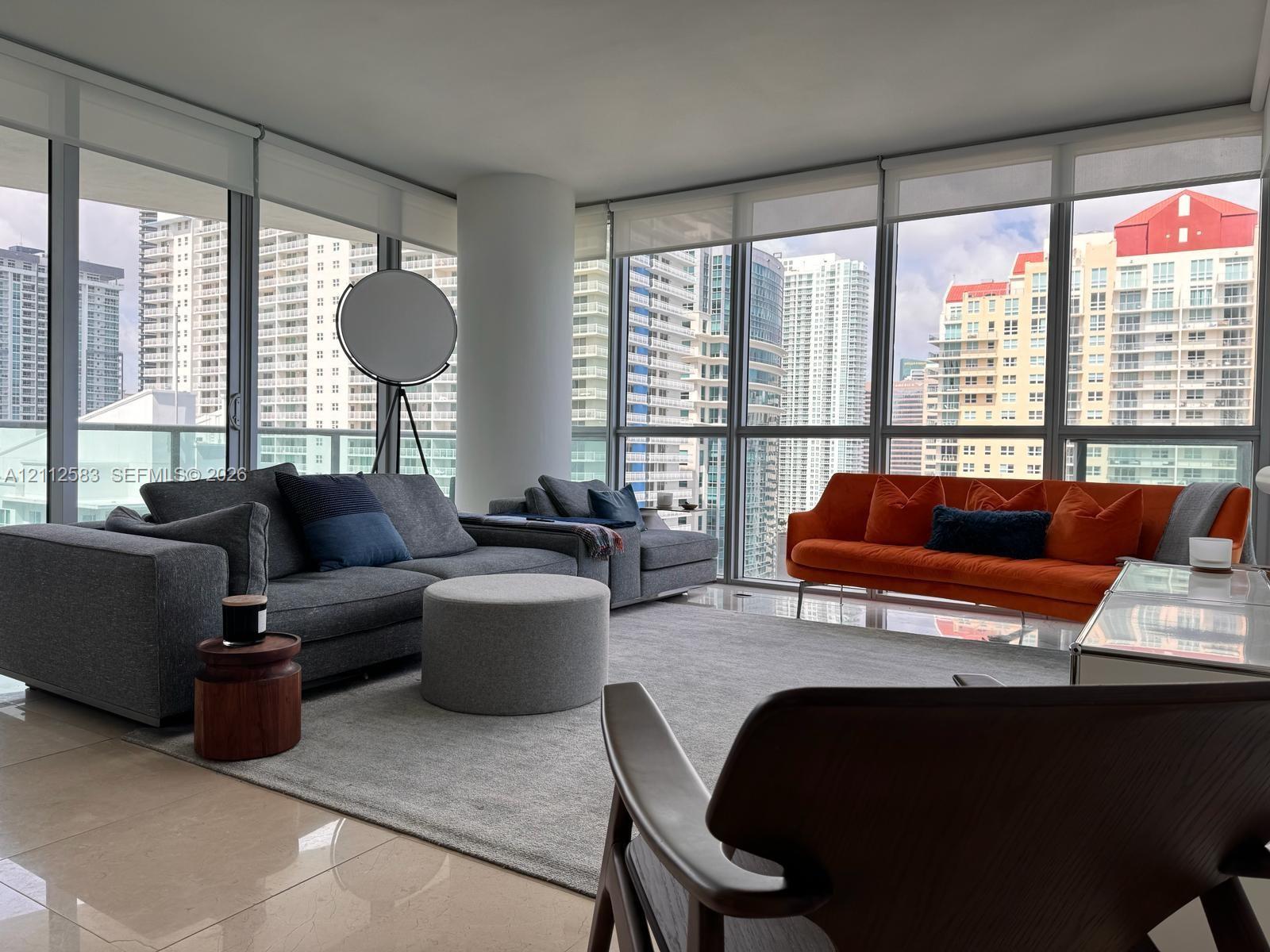Floor-to-ceiling windows, ceramic tile flooring, and a structural column Floor-to-ceiling windows, ceramic tile flooring, and a structural column