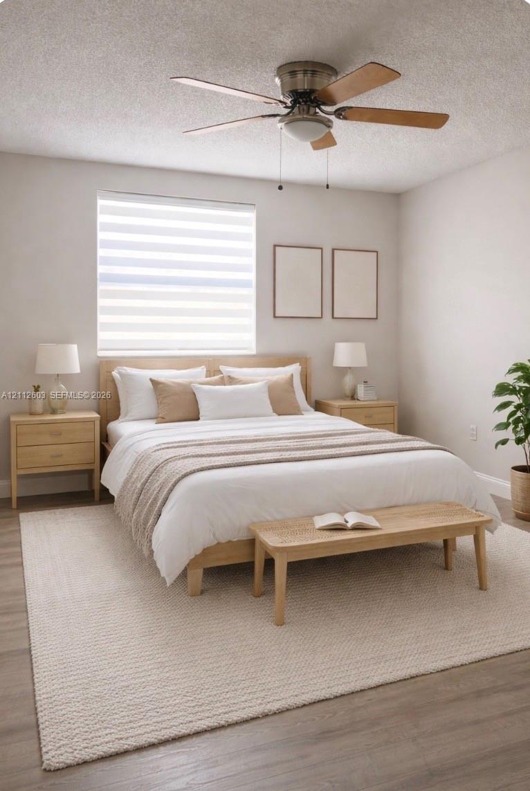 Master bedroom featuring wood-finish flooring, a neutral color palette, tiered roller shades, and a ceiling fan with integrated lighting