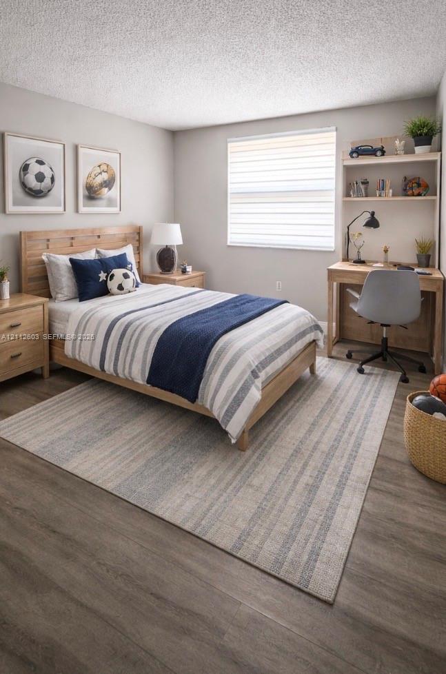 Bedroom featuring wood-finish flooring