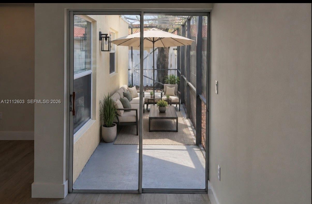 Screened-in patio featuring concrete flooring, a metal frame, exterior wall-mounted lighting, wrap around screened porch. Screened-in patio featuring concrete flooring, a metal frame, exterior wall-mounted lighting, wrap around screened porch.