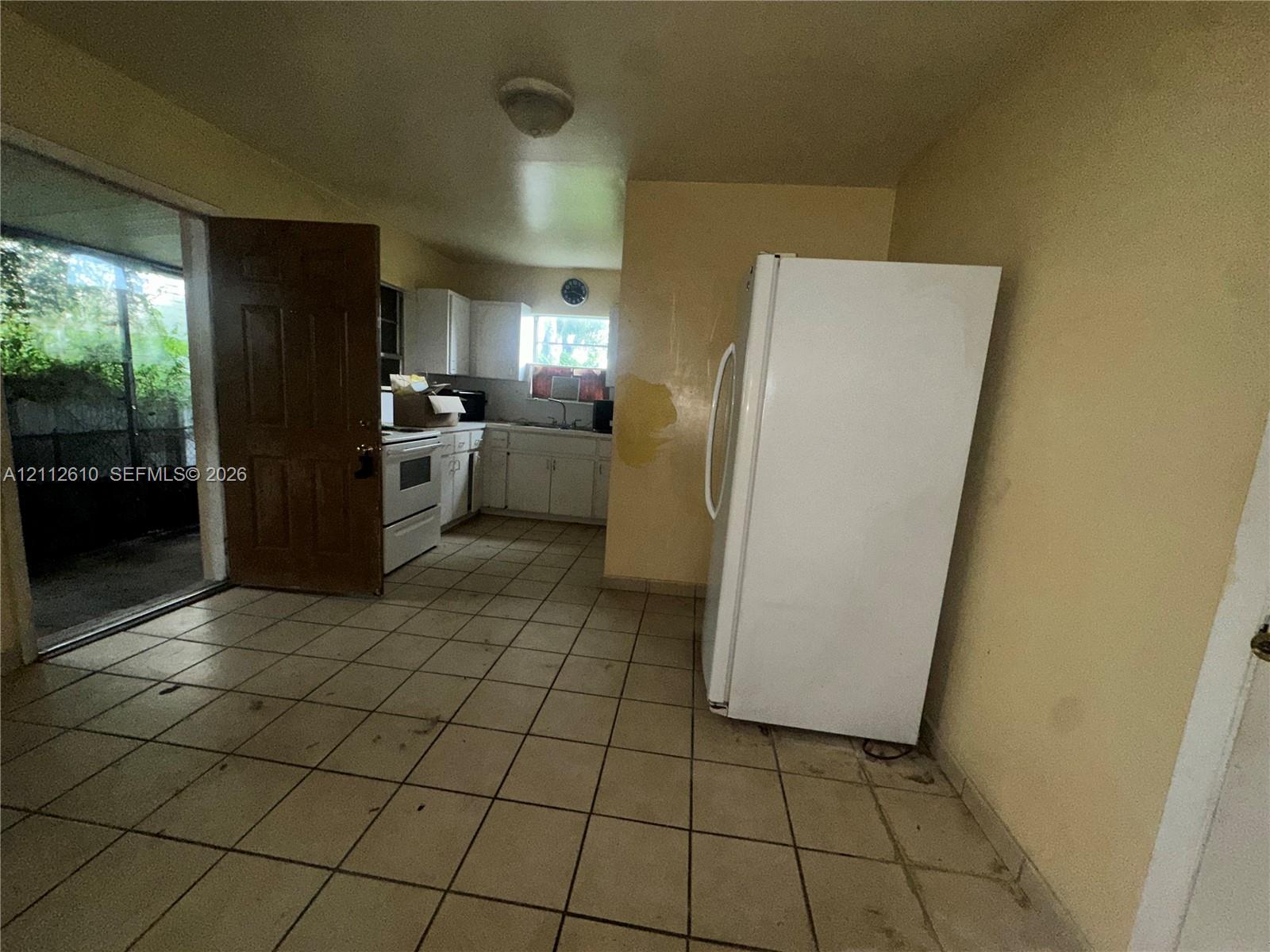 Kitchen featuring ceramic tile flooring, white cabinetry, and a freestanding white range
