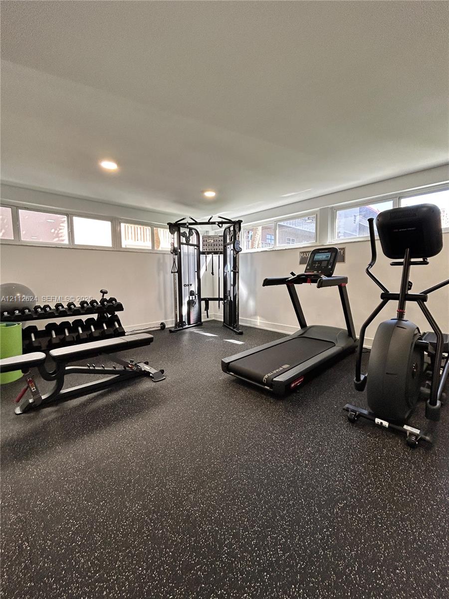Flex space featuring speckled rubberized flooring, recessed lighting, and horizontal clerestory windows