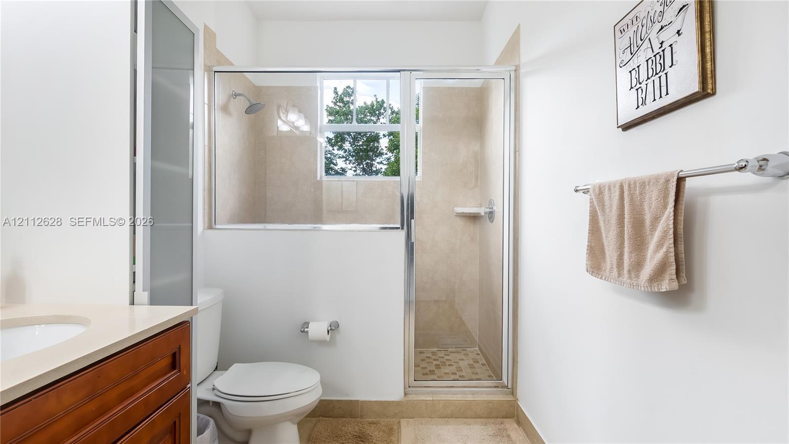 A luxurious ensuite bathroom complete with an expansive dual-vanity, abundant counter space, and warm finishesdesigned to elevate your morning routine and provide a serene, resort-style experience.