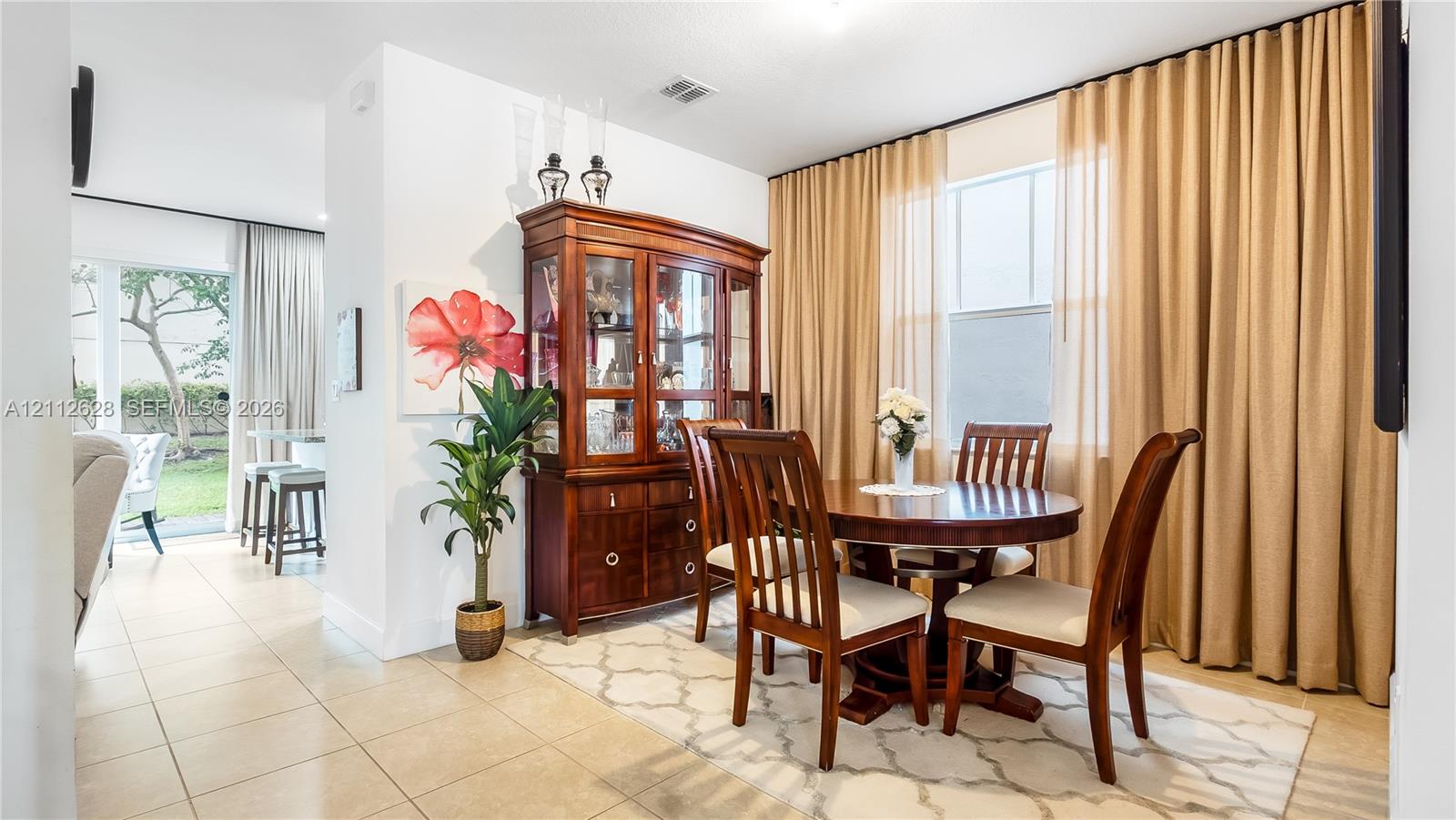 Framed by beautiful drapery and soft natural light, this dining area elevates every meal into an experienceperfect for both relaxed evenings and special occasions.