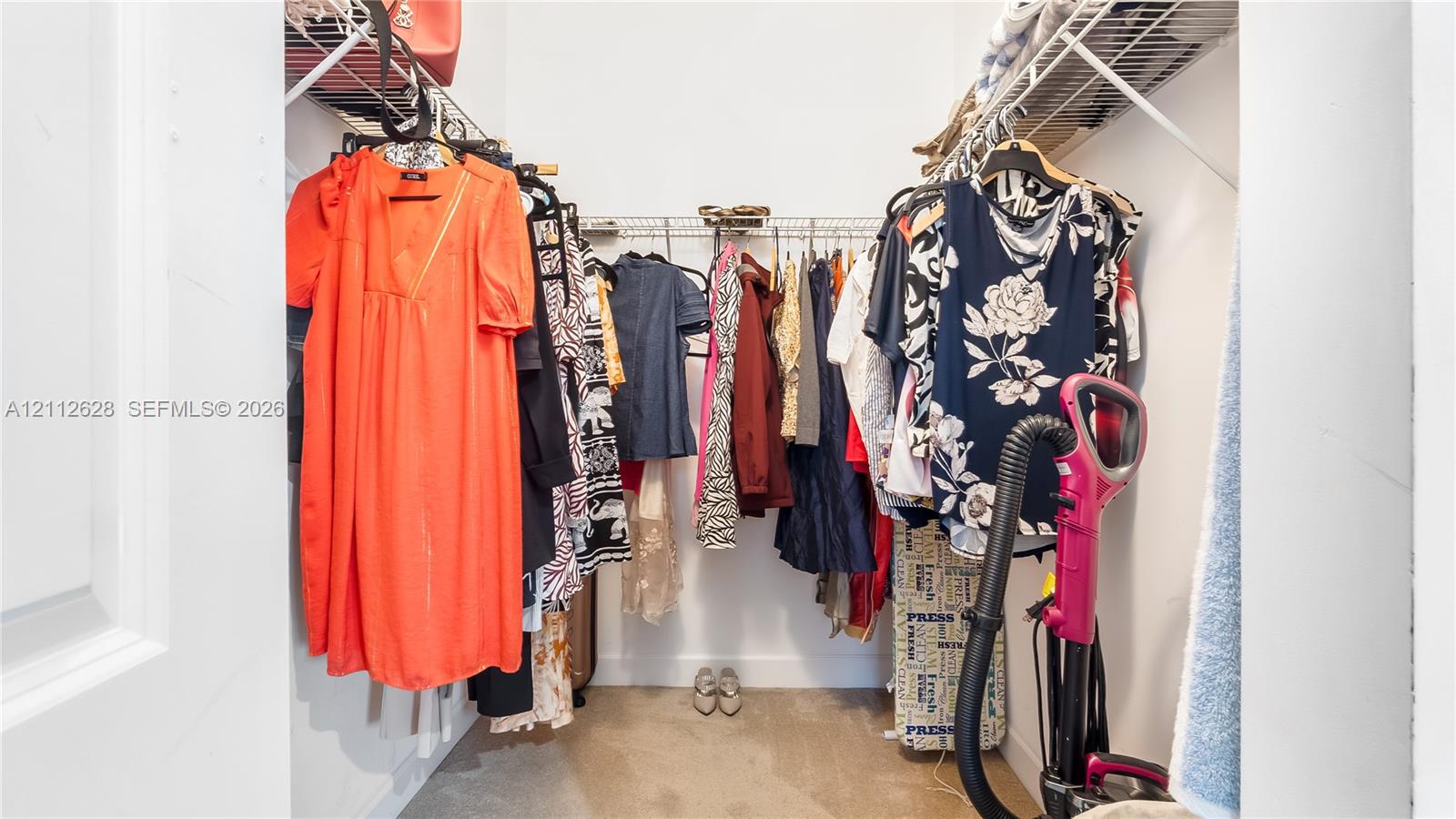 A spacious walk-in closet offering generous hanging space, open shelving, and effortless organizationperfect for curating your wardrobe and keeping everyday essentials beautifully within reach.