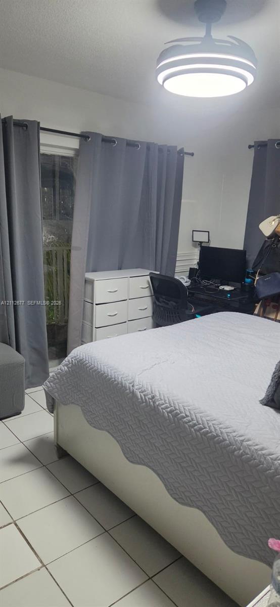 Room featuring white ceramic tile flooring and a modern LED flush-mount ceiling fixture with an integrated fan