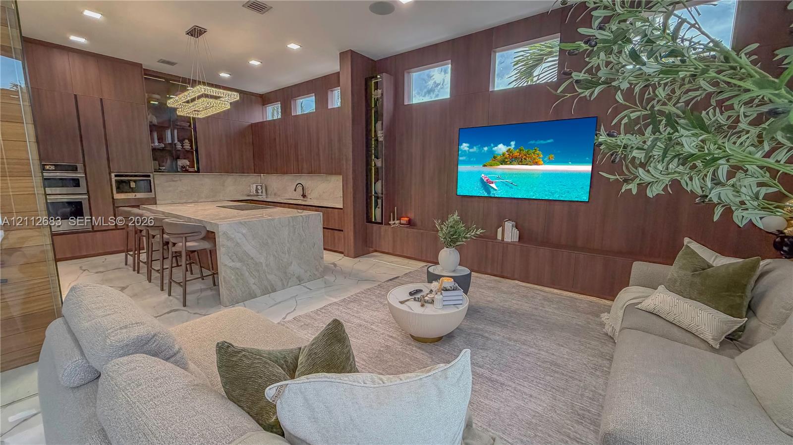 Open concept room featuring floor-to-ceiling wood-panelled walls, an expansive stone kitchen island, recessed lighting, clerestory windows, and built-in stainless steel appliances
