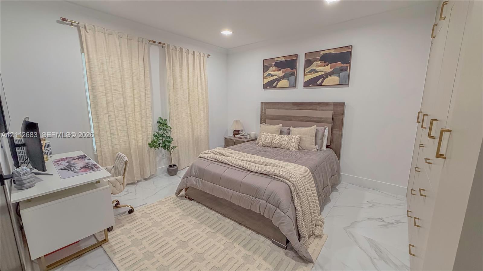 Neutral-toned interior featuring large-format tile flooring with a veined pattern, recessed ceiling lighting, and floor-to-ceiling built-in cabinetry with metallic hardware