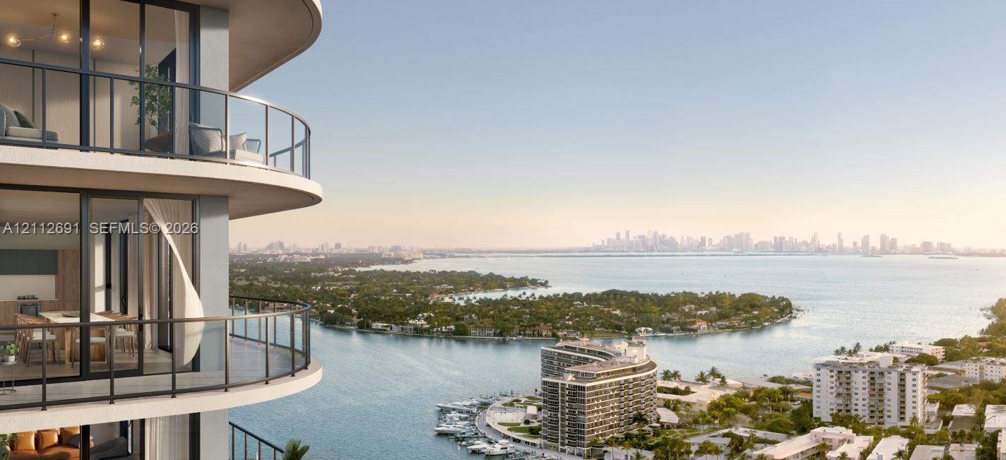 Curved private balconies with floor-to-ceiling glass sliding doors and dark metal railings