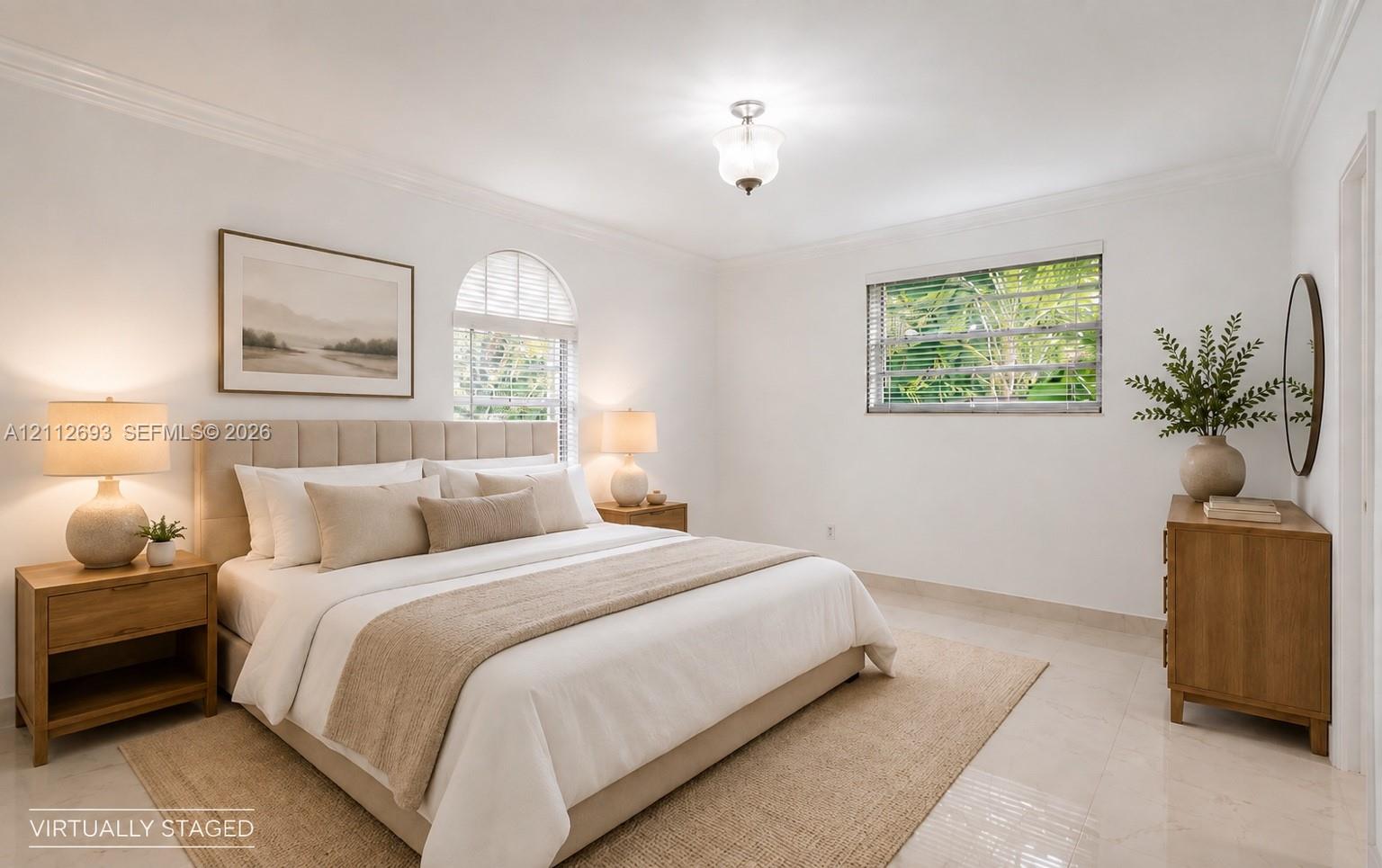 Neutral-toned tile flooring, arched window with horizontal blinds, multi-pane window, crown molding, and semi-flush mount ceiling fixture