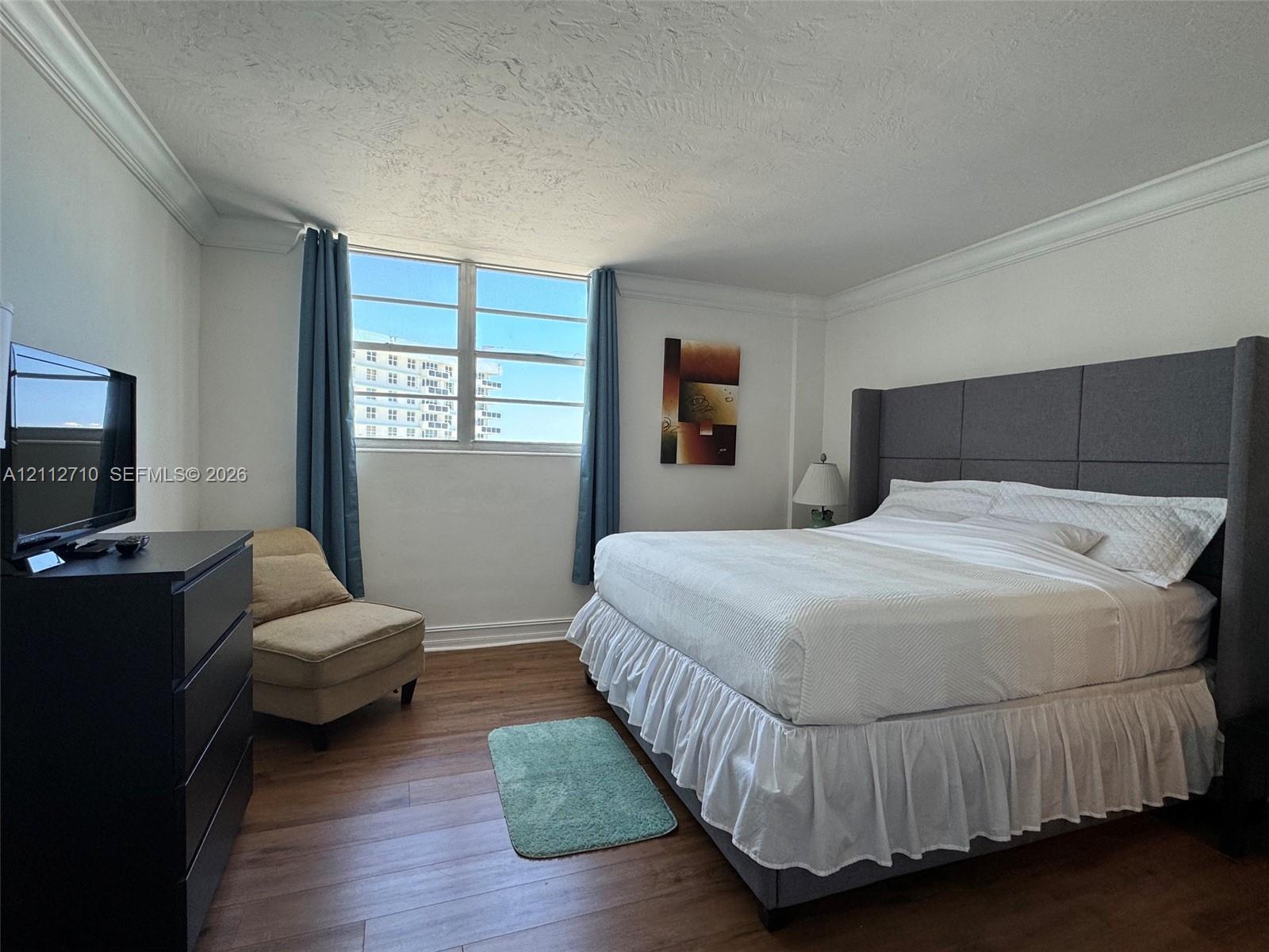 Wood-finish flooring and crown molding featured throughout