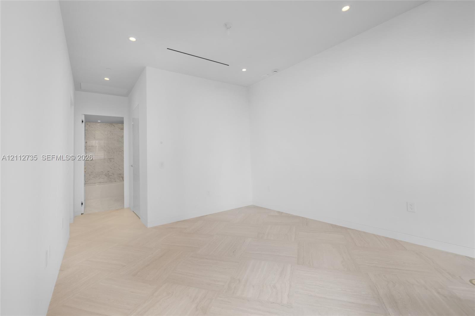 Parquet wood-finish flooring, recessed lighting, and a linear slot diffuser