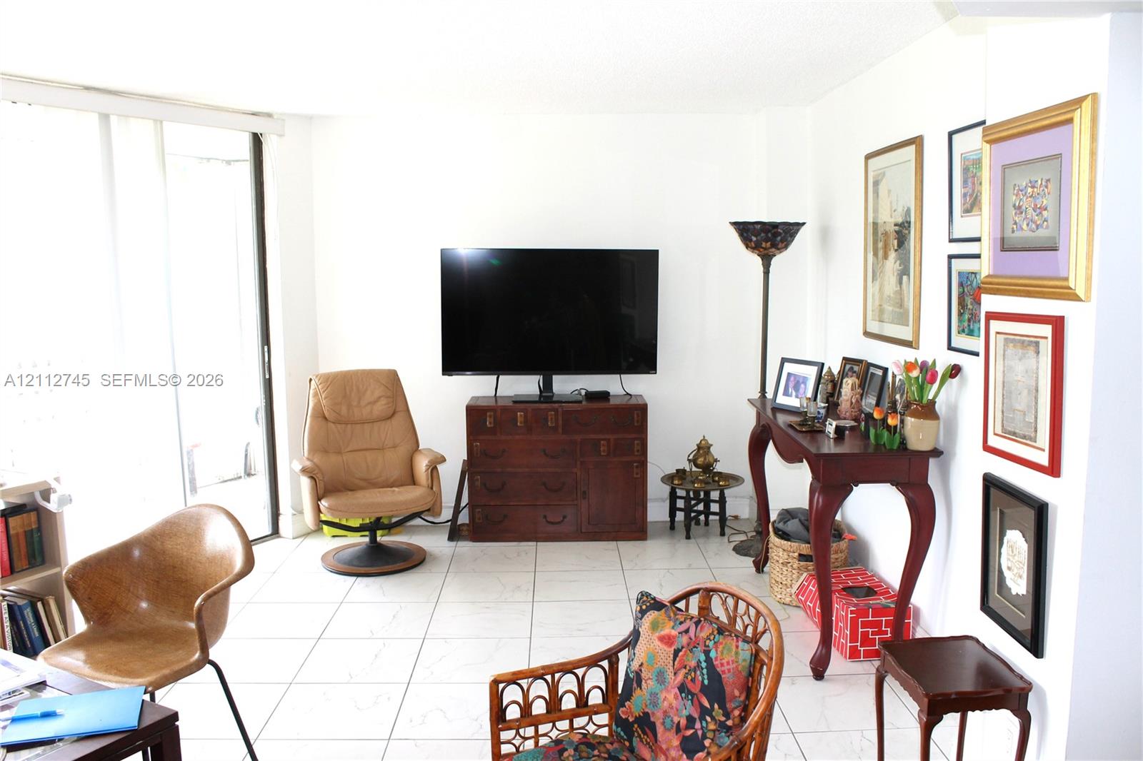 Interior living space featuring ceramic tile flooring and sliding glass doors