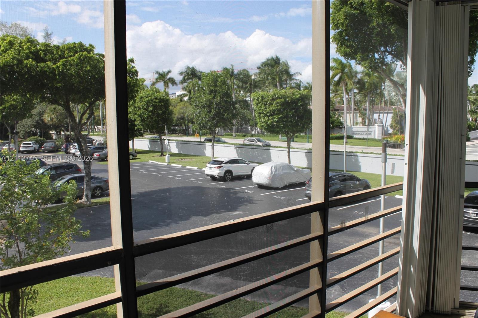 Screened-in enclosure featuring horizontal metal railings and vertical framing Screened-in enclosure featuring horizontal metal railings and vertical framing