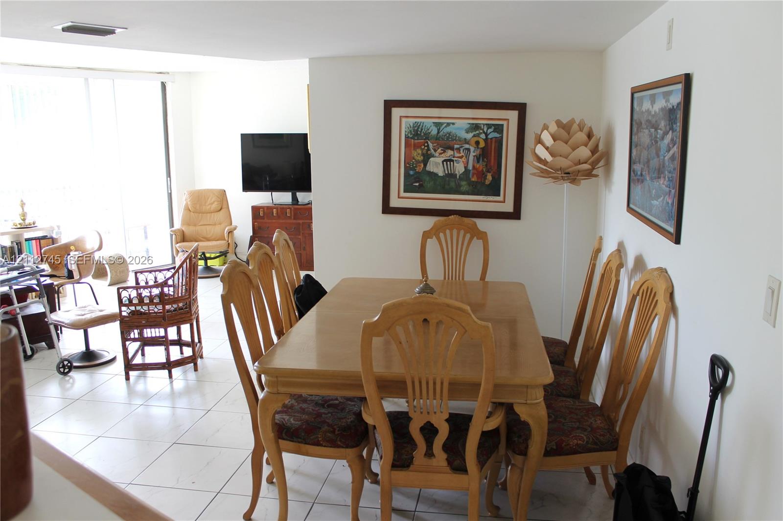 Neutral-toned ceramic tile flooring throughout, recessed ceiling lighting, and floor-to-ceiling glass sliding doors