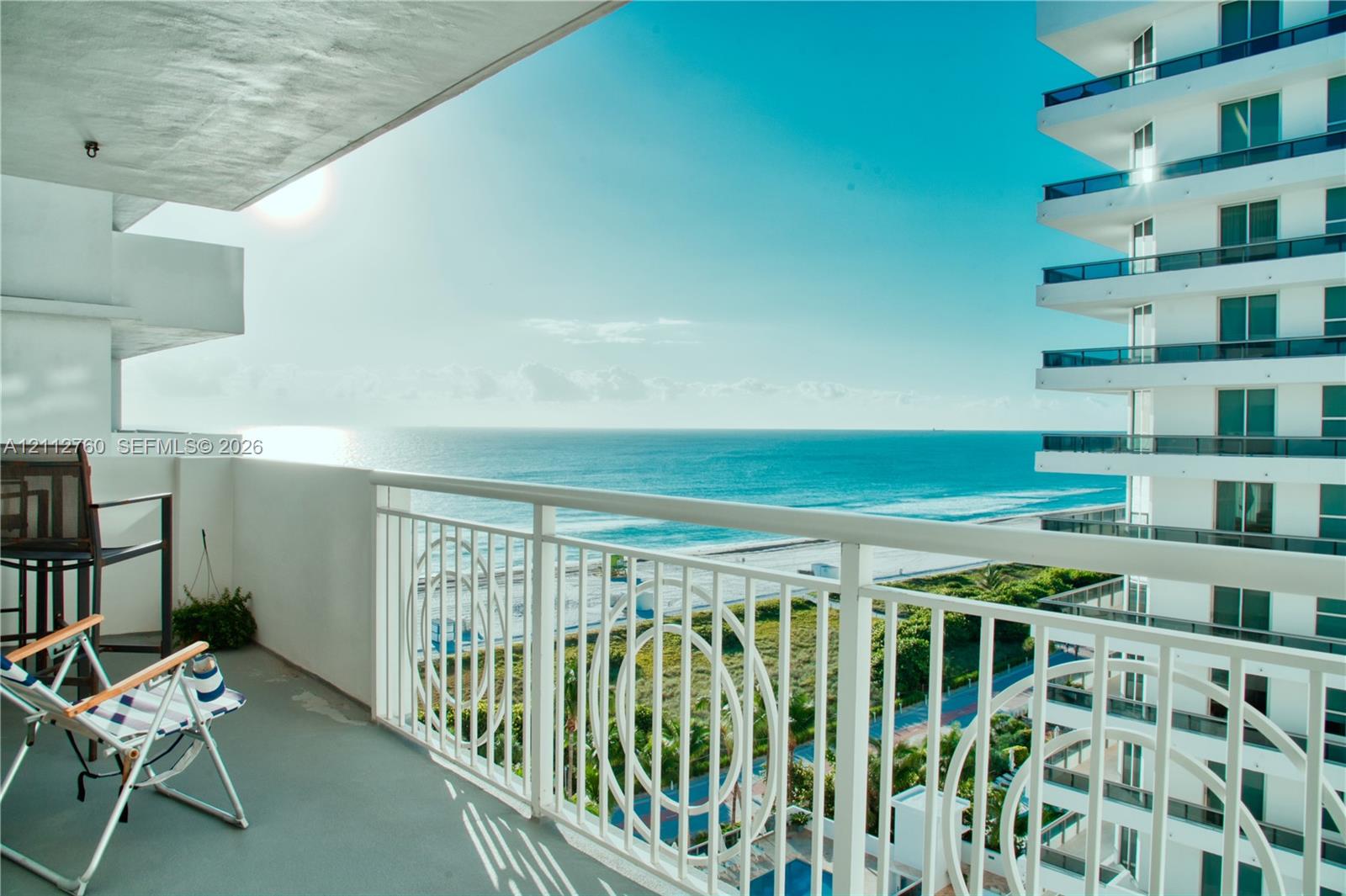Private balcony featuring white metal railings with decorative circular detailing and oceanfront exposure Private balcony featuring white metal railings with decorative circular detailing and oceanfront exposure