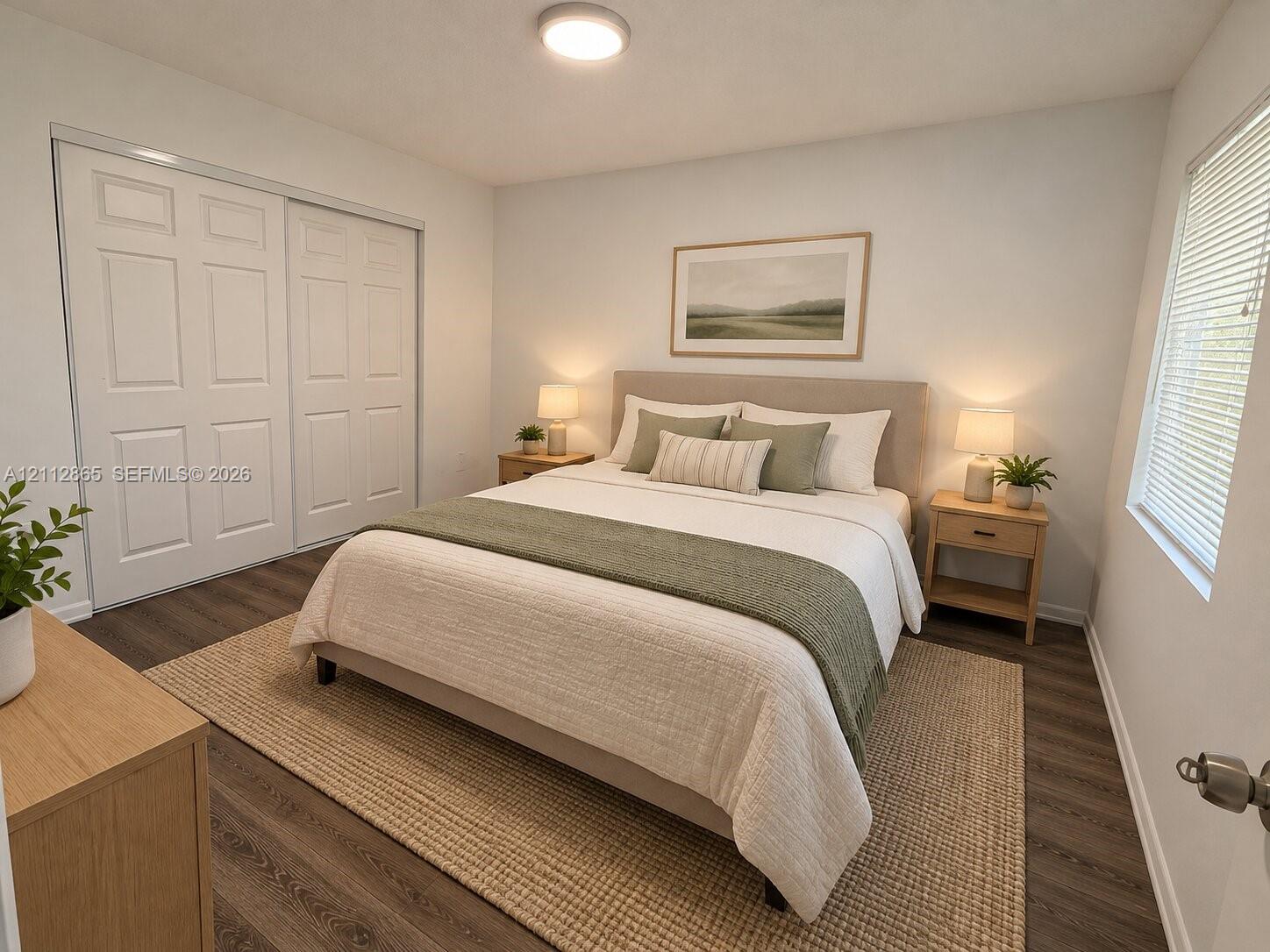 Wood-finish flooring, double-panel sliding closet doors, and recessed ceiling lighting