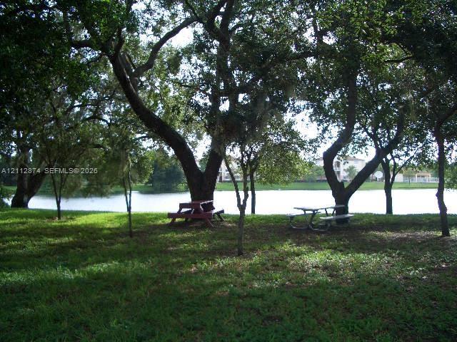 Expansive grounds featuring mature shade trees and direct frontage on a private lake