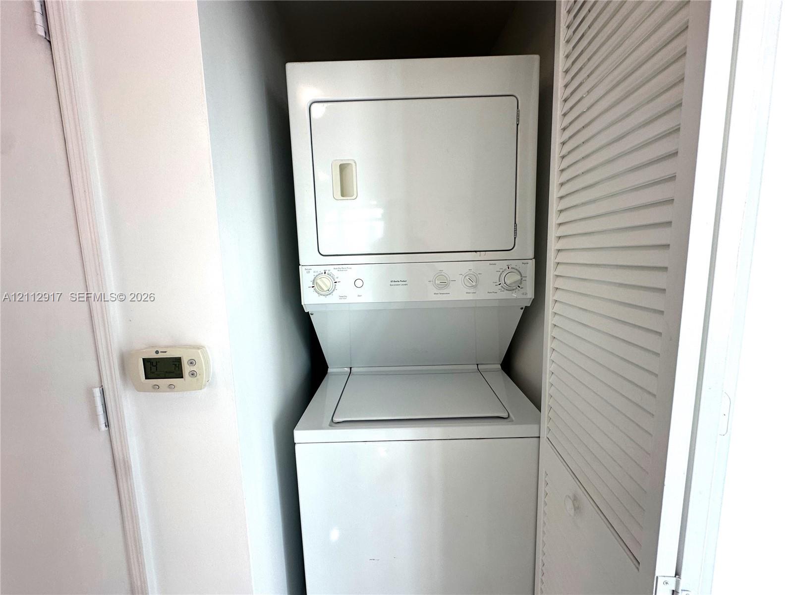Stacked washer and dryer unit with louvered closet door access