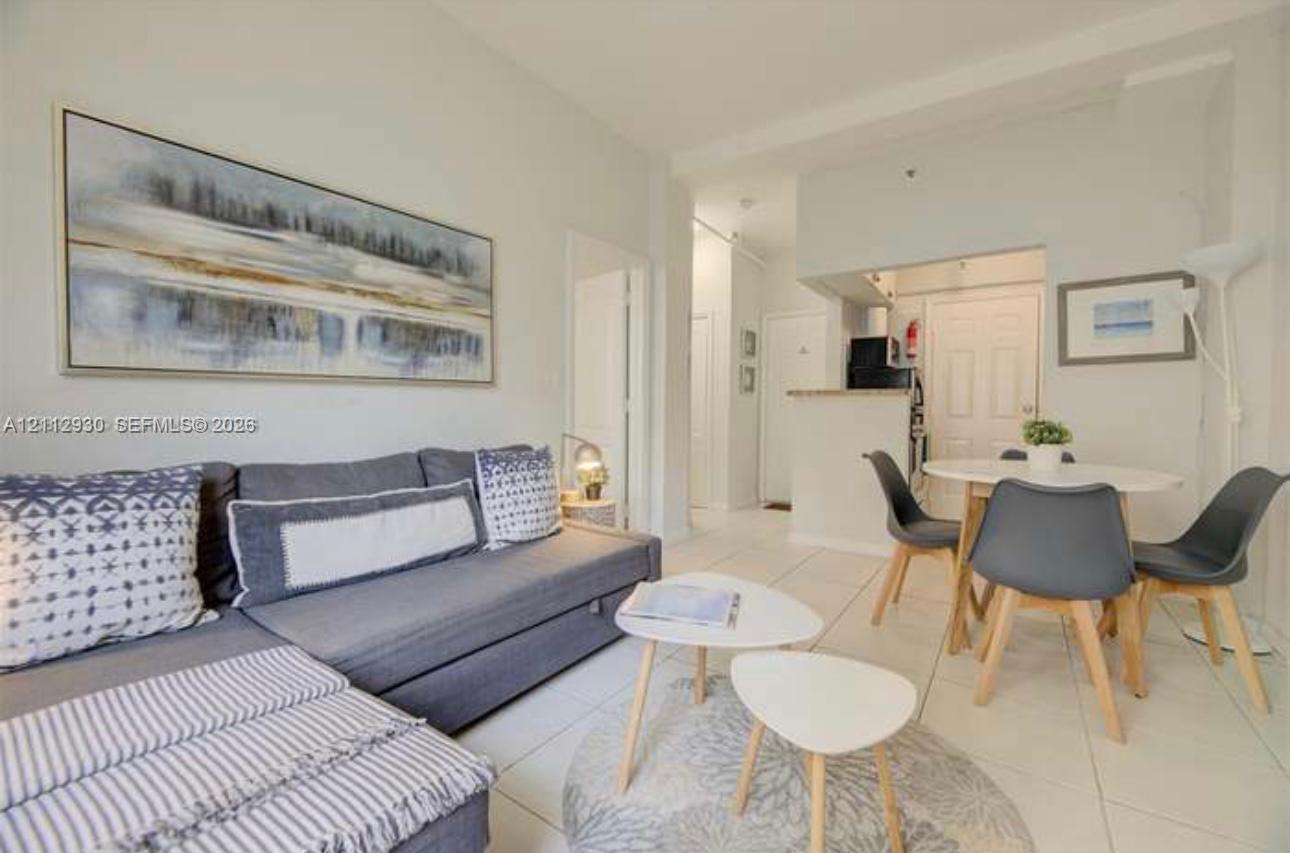 Open-concept interior featuring light-colored tile flooring, neutral wall paint, and recessed ceiling lighting Open-concept interior featuring light-colored tile flooring, neutral wall paint, and recessed ceiling lighting