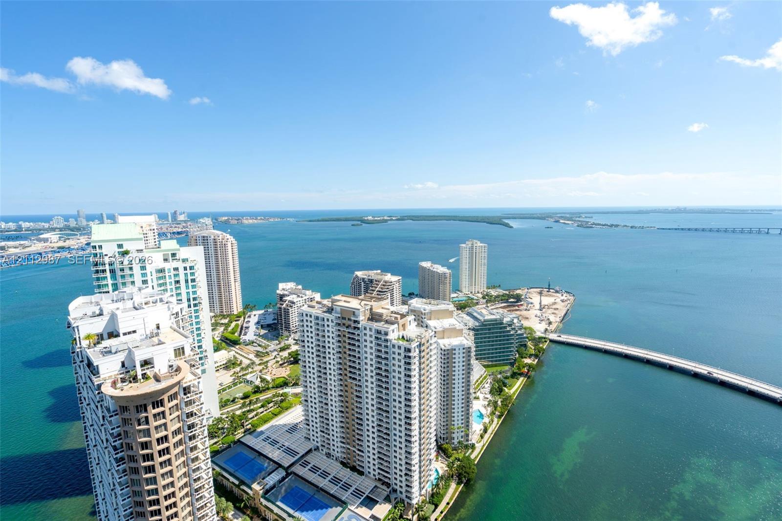 High-rise aerial perspective capturing expansive coastal surroundings, maritime waterways, and metropolitan architecture