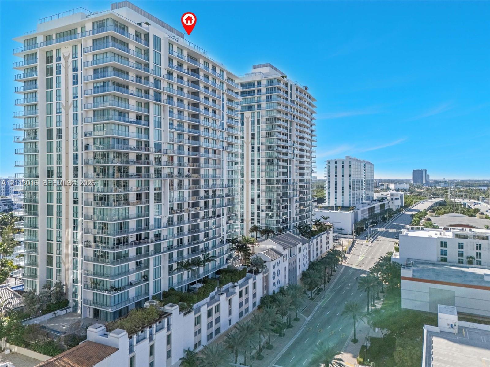 High-rise architectural structure featuring glass-paneled balconies, floor-to-ceiling windows, and rooftop terracing High-rise architectural structure featuring glass-paneled balconies, floor-to-ceiling windows, and rooftop terracing