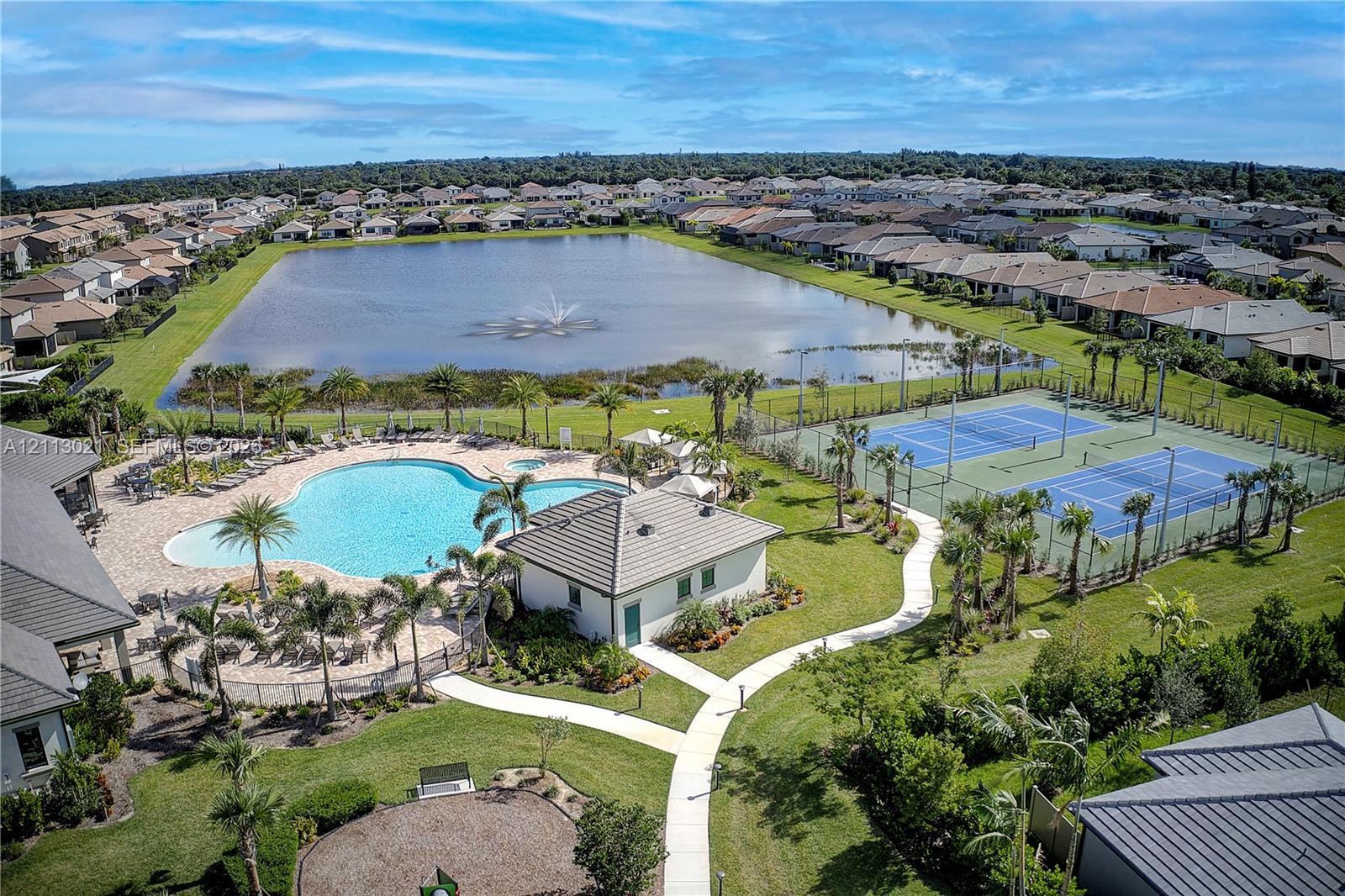 Community amenities featuring a swimming pool, two tennis courts, and a water feature with a fountain