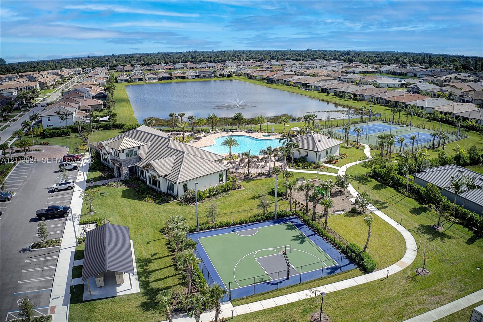 Community amenities featuring a clubhouse, swimming pool, basketball court, tennis courts, and a central pond