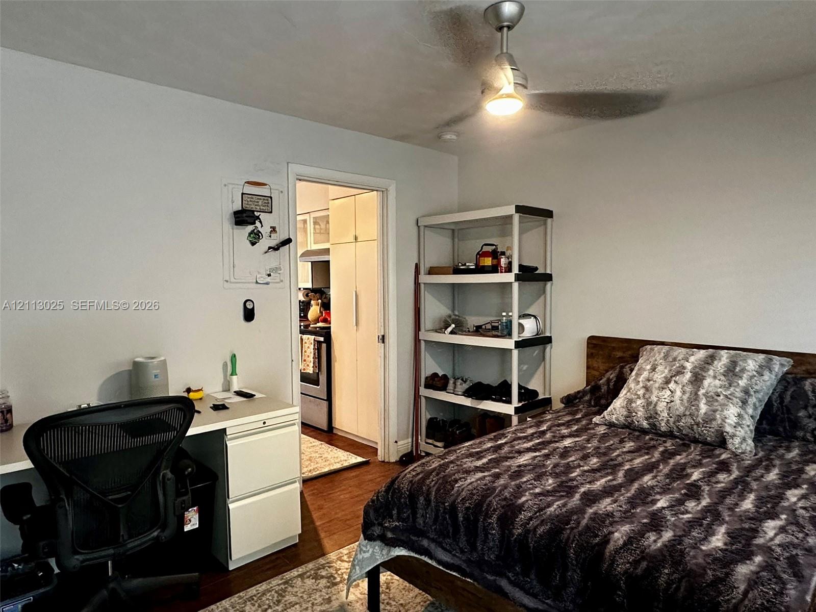 Interior space featuring wood-finish flooring and a central ceiling fan with integrated lighting