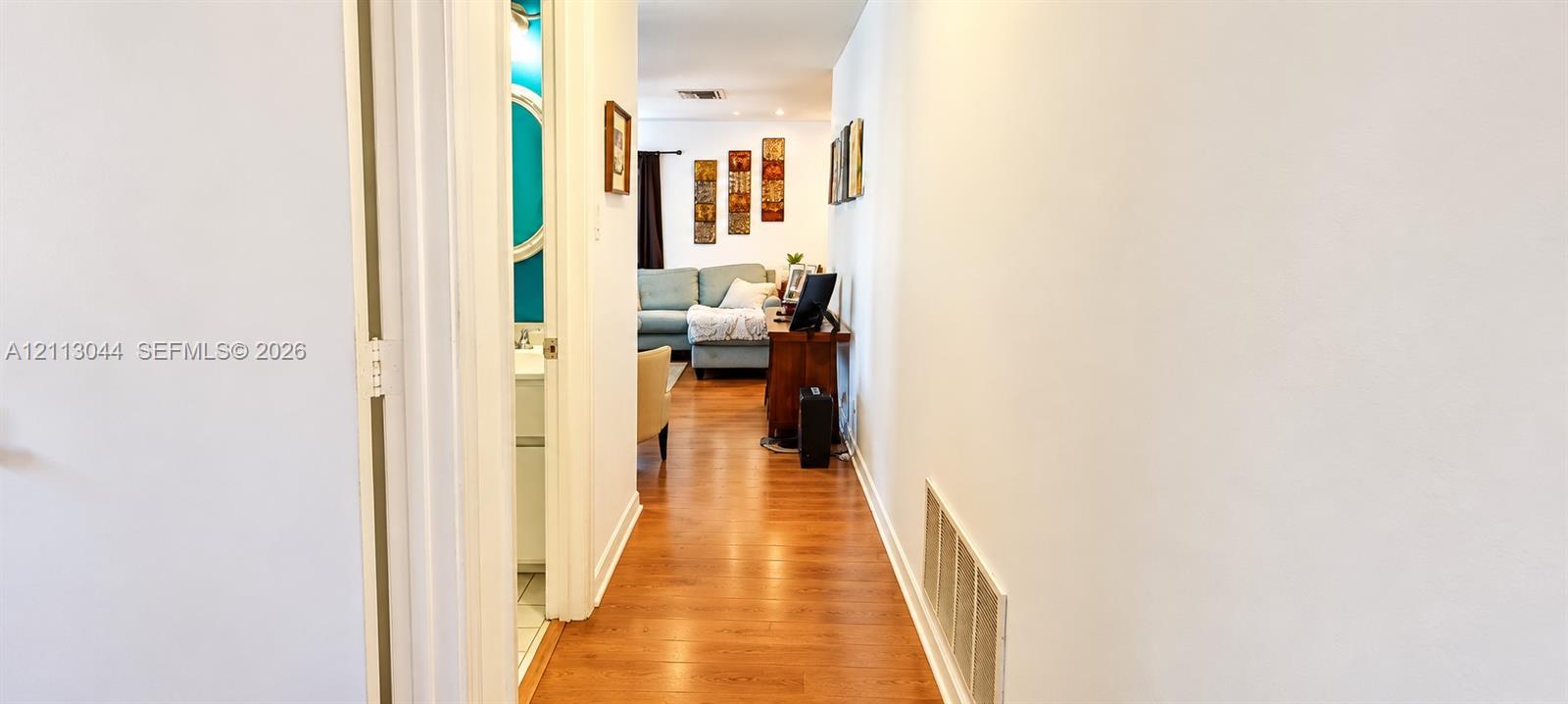 Hallway featuring wood-finish flooring and recessed lighting