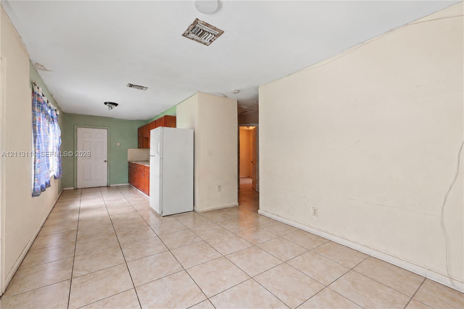 Interior space featuring tile flooring and wood-finish cabinetry